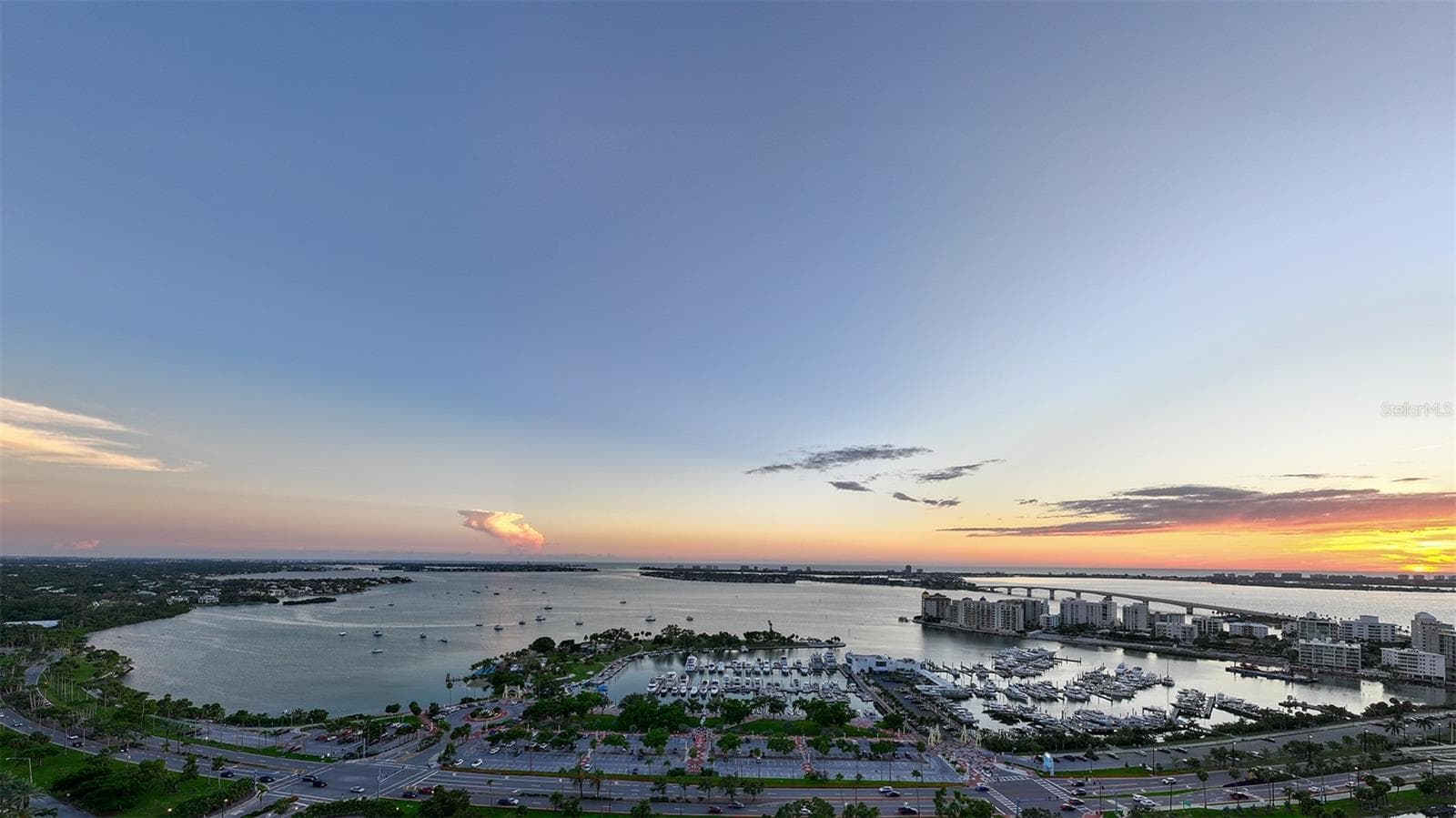Sweeping panoramic views from the Sky Speakeasy showcase Sarasota Bay, The Gulf of Mexico, and the iconic Ringling Bridge, creating a breathtaking backdrop for unforgettable sunset moments high above the city. - 65 S PALM AVE #1503, SARASOTA