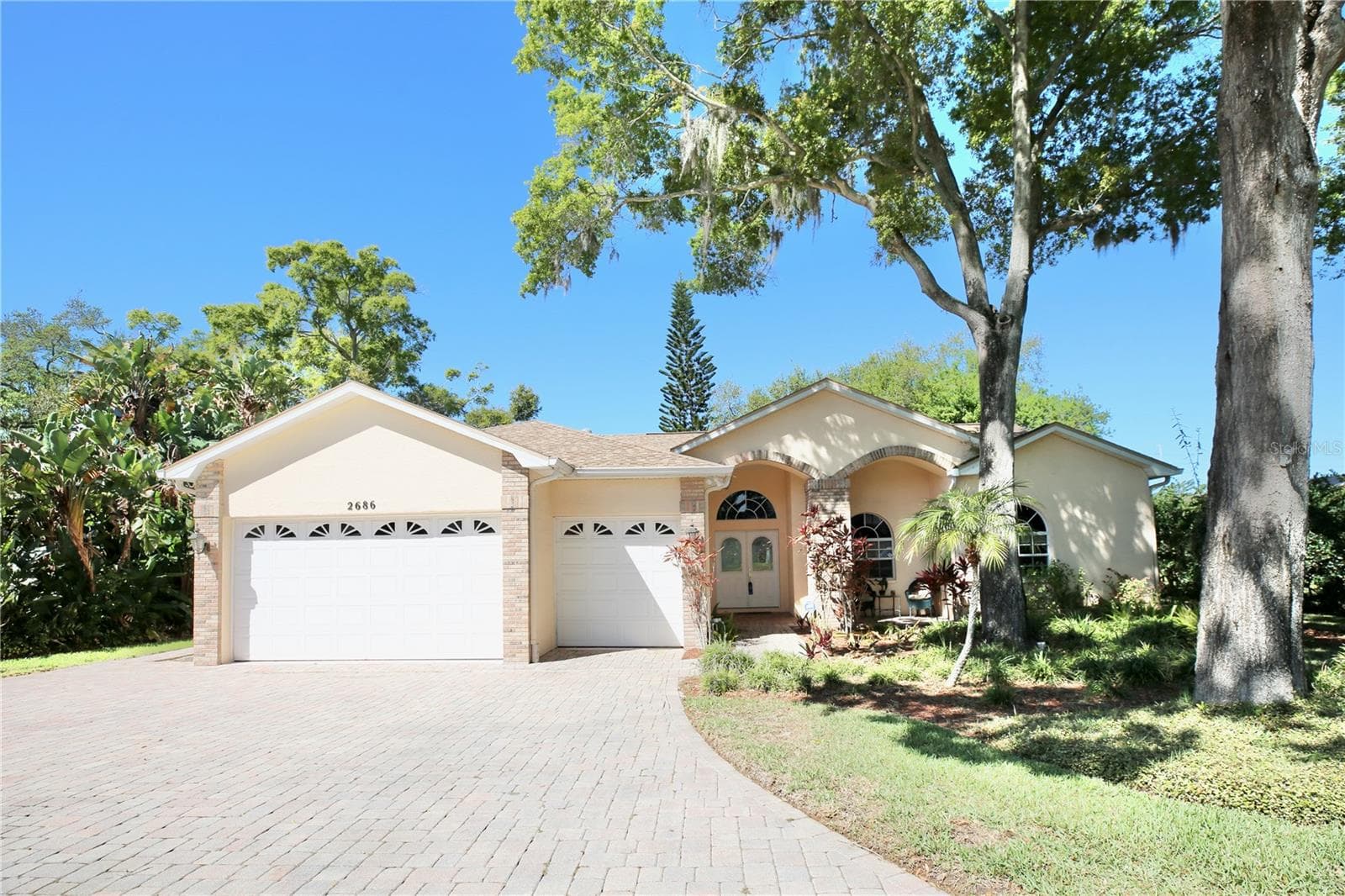 Lovely Roundtop windows and multiple roof lines adorned home with such attention to detail - 2686 CRYSTAL CIR, DUNEDIN