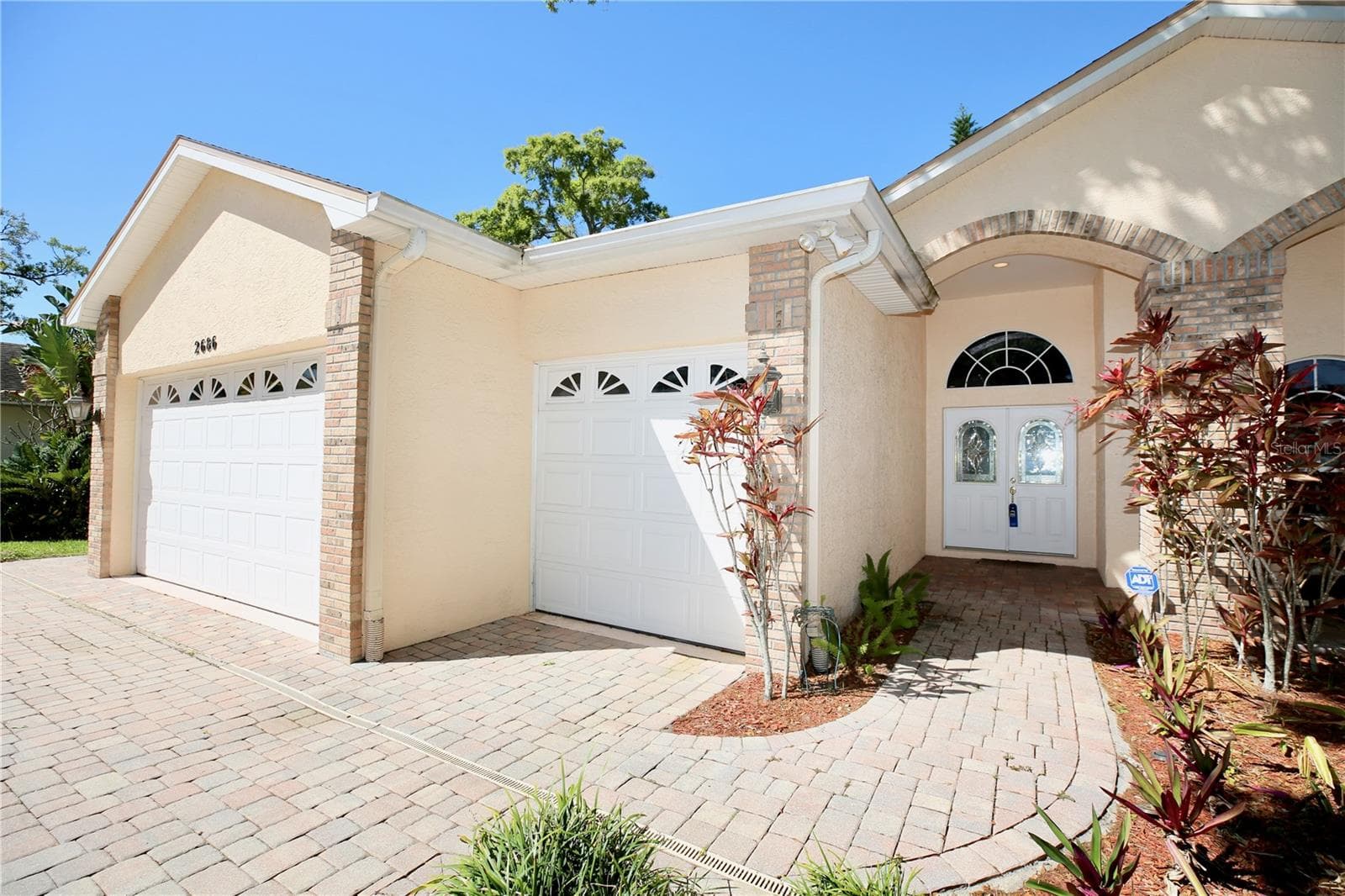 3 car garage and ample parking with paver driveway and walkway - 2686 CRYSTAL CIR, DUNEDIN