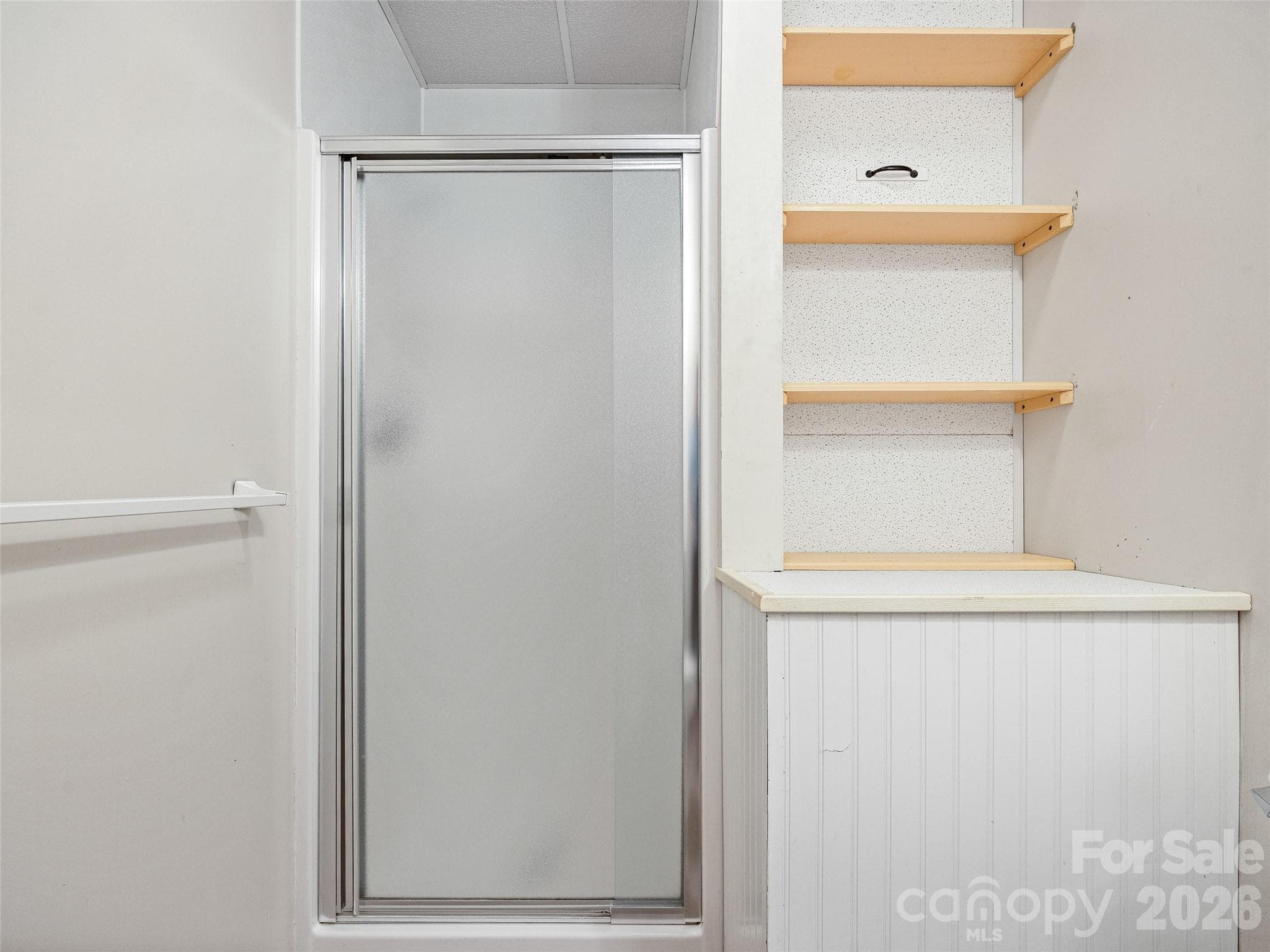 Basement apartment shower. Water heater is located behind the removeable shelves - Hendersonville