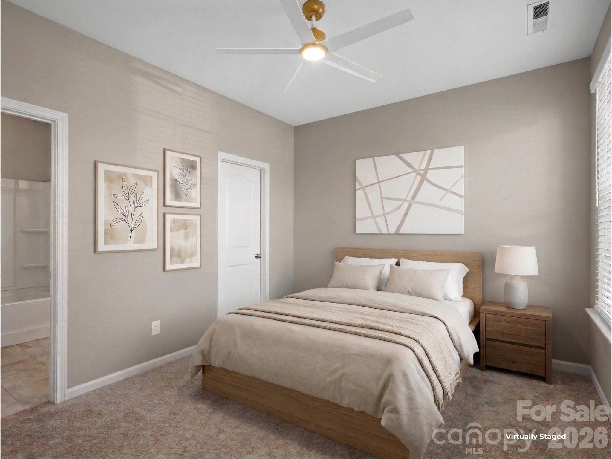 This main floor bedroom has an en suite full bathroom that also has an entrance from the hallway. - Charlotte