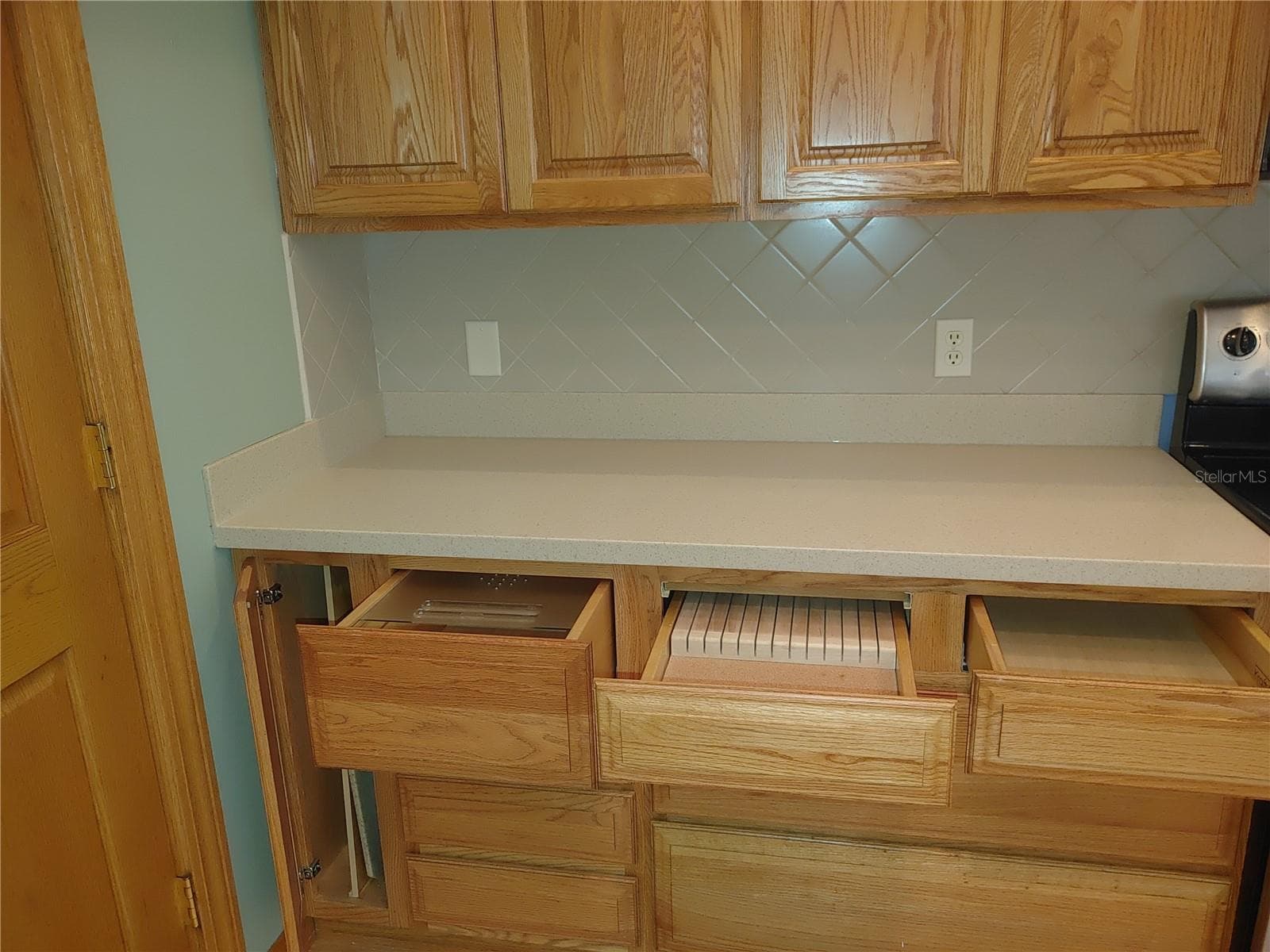 Left cabinet for cookie sheets, top left is a bread drawer, middle knife drawer - 7604 52ND TER E, BRADENTON