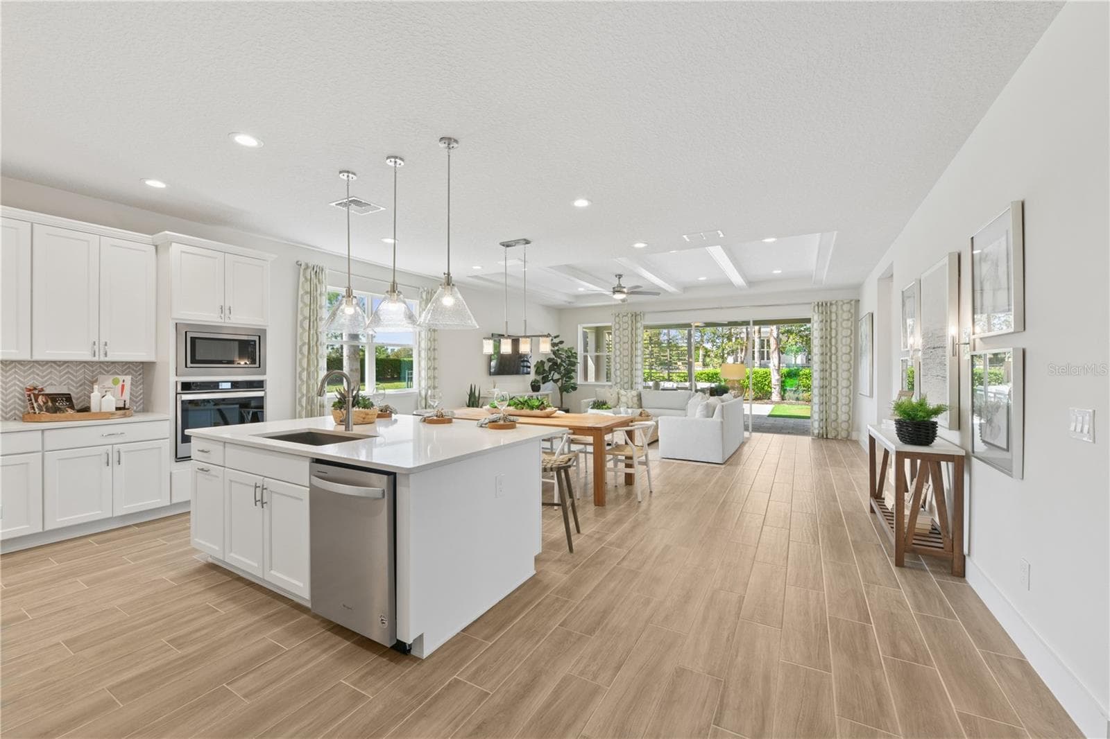 Open-concept living and dining with abundant light, breezy flow, and a calm, inviting ambiance. - 2418 PARK RIDGE ST, APOPKA