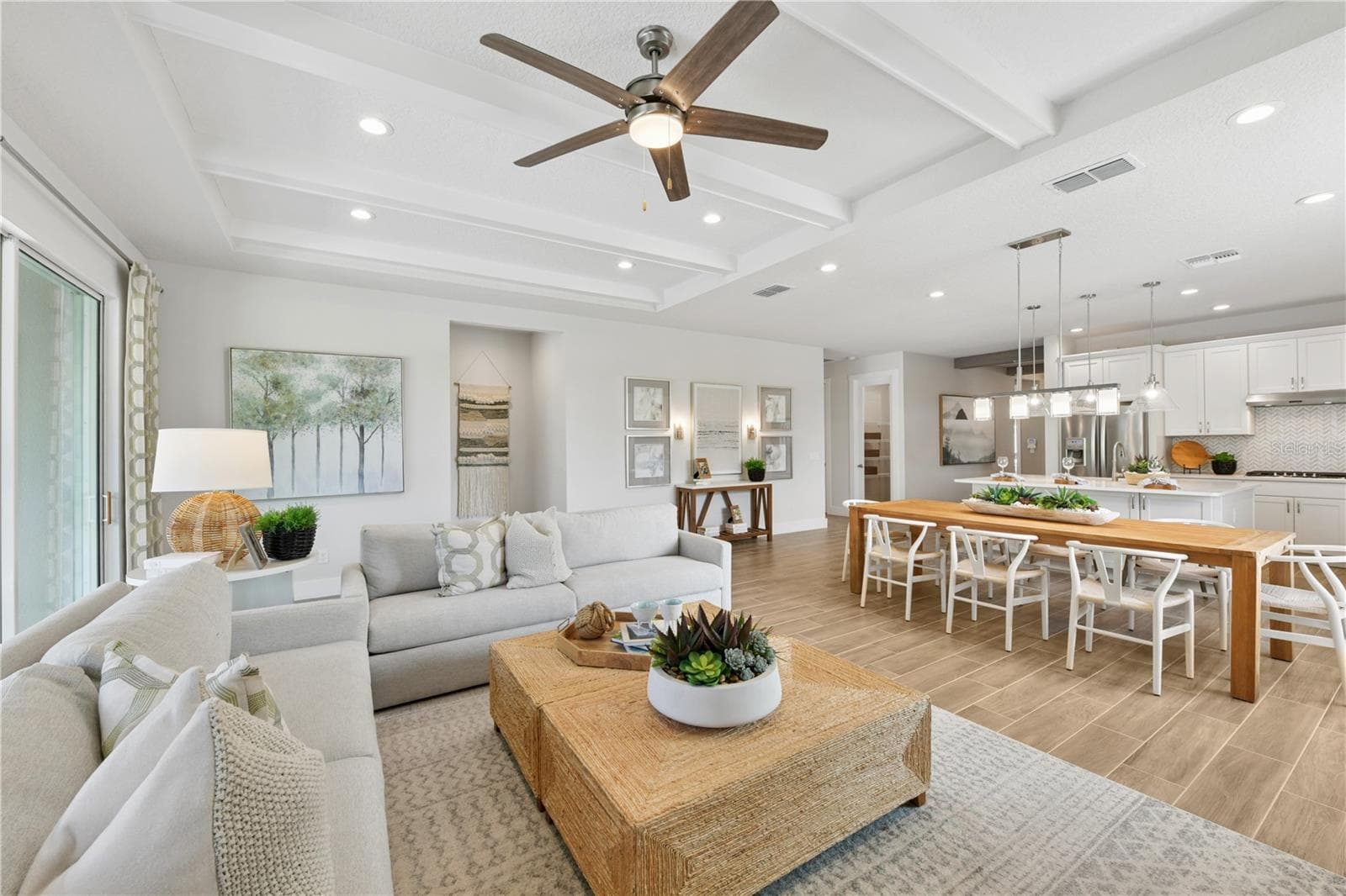 Open-concept living and dining with abundant light, breezy flow, and a calm, inviting ambiance. - 2418 PARK RIDGE ST, APOPKA