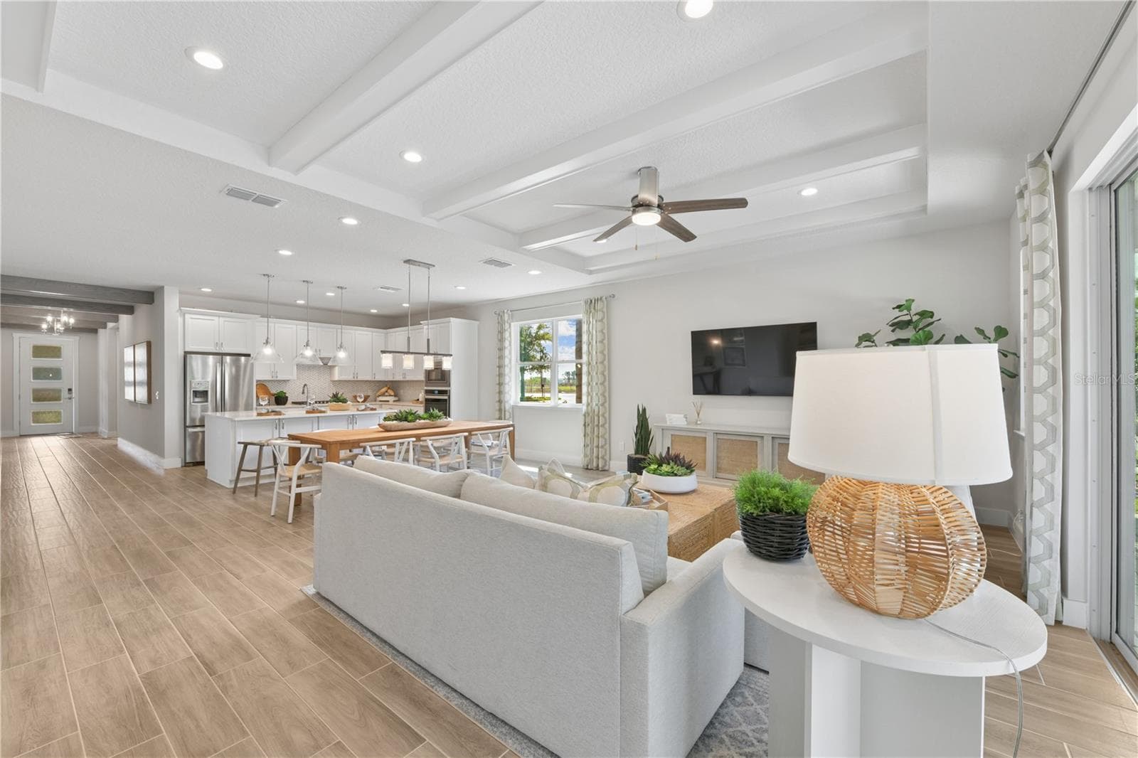 Tray ceilings highlight the great room with designer beams providing texture and flow - 2418 PARK RIDGE ST, APOPKA