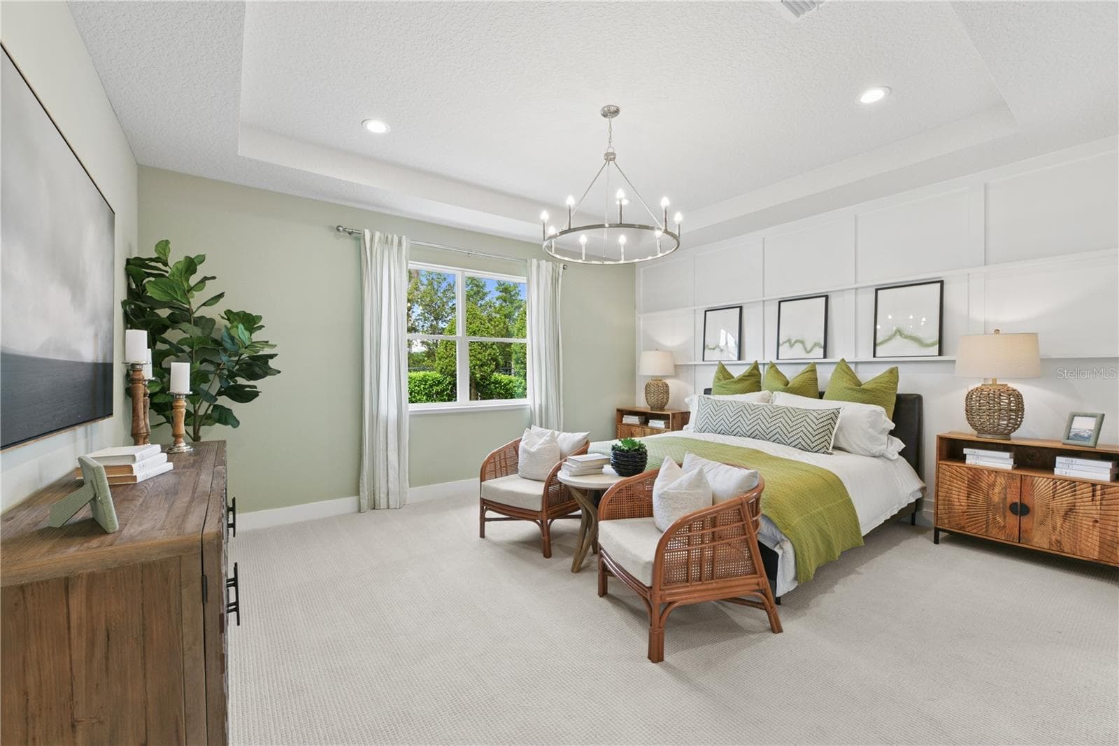 Spacious primary suite with soft, calming tones and a luxurious ensuite featuring a freestanding tub, walk-in shower, dual vanities, and walk-in closet. - 2418 PARK RIDGE ST, APOPKA