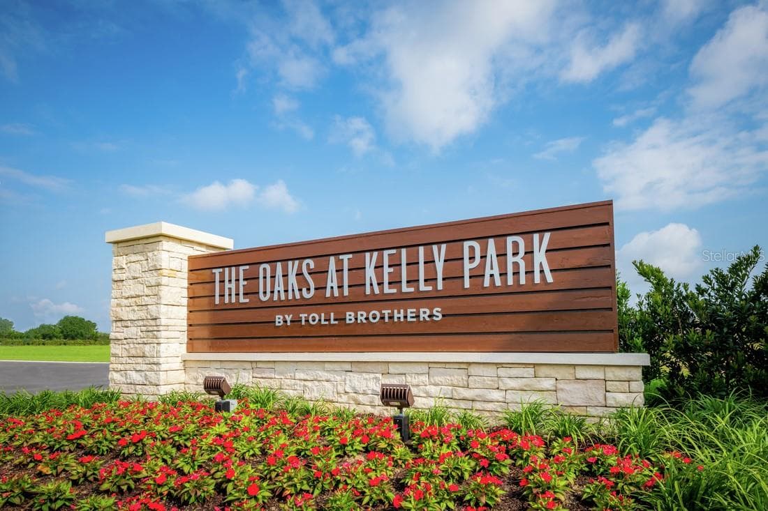 Community entrance featuring lush landscaping and a statement entrance monument - 2418 PARK RIDGE ST, APOPKA