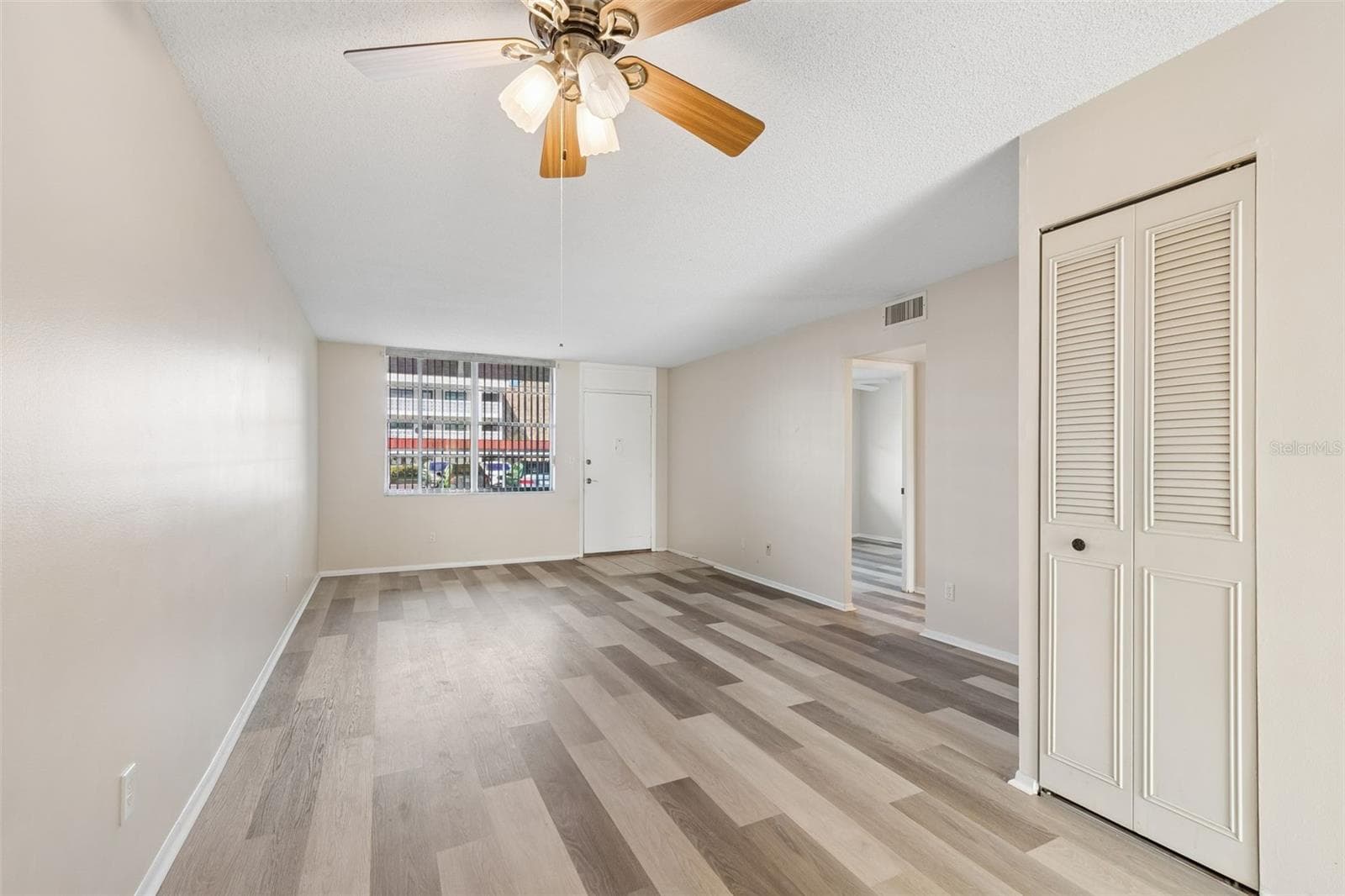 Living room - New luxury vinyl flooring - 5095 BAY ST NE #110, ST PETERSBURG