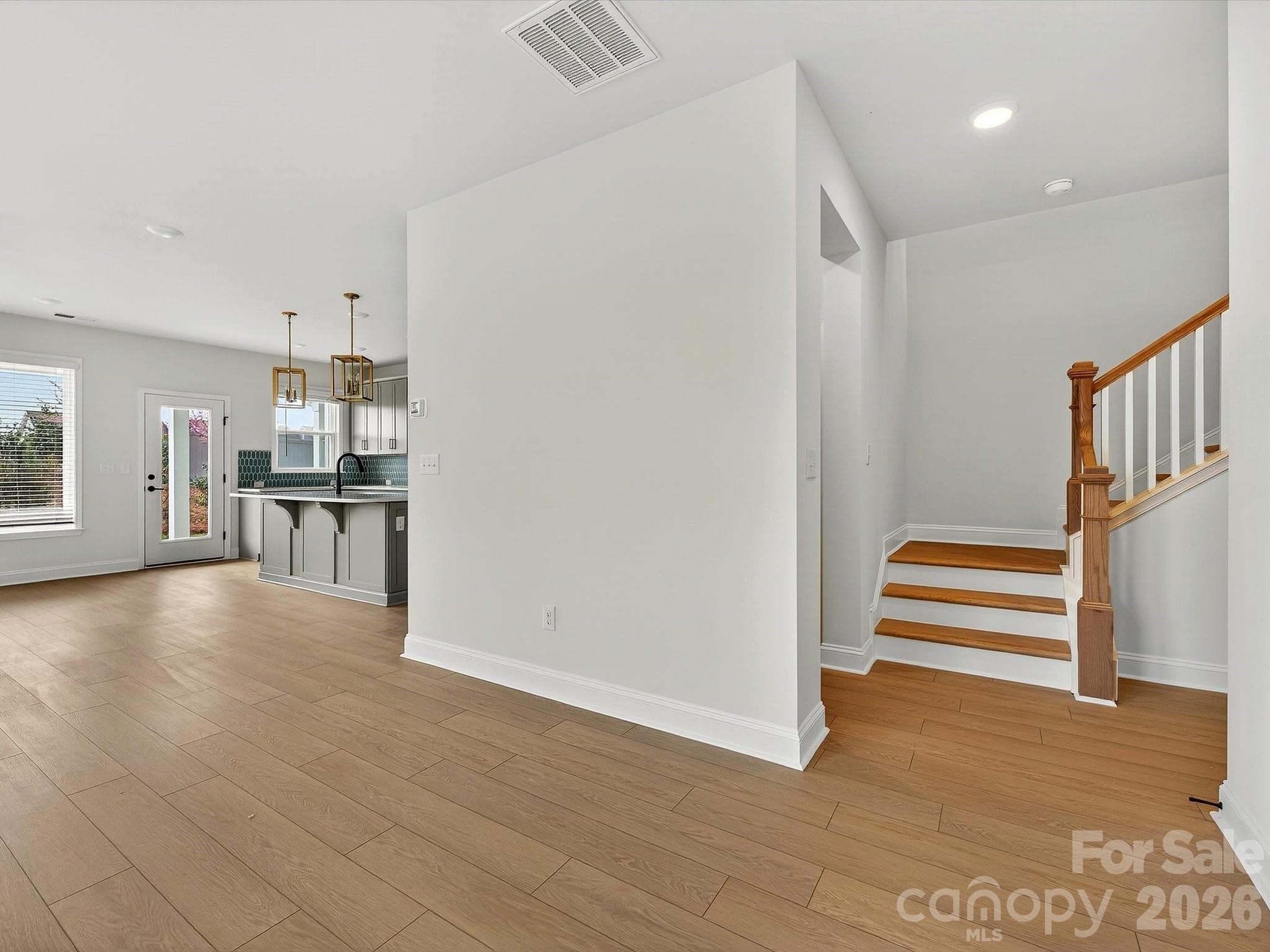 LVP flooring throught the main floor with compostie LVP stair treads - 218 Quartz Hill Way, Waxhaw