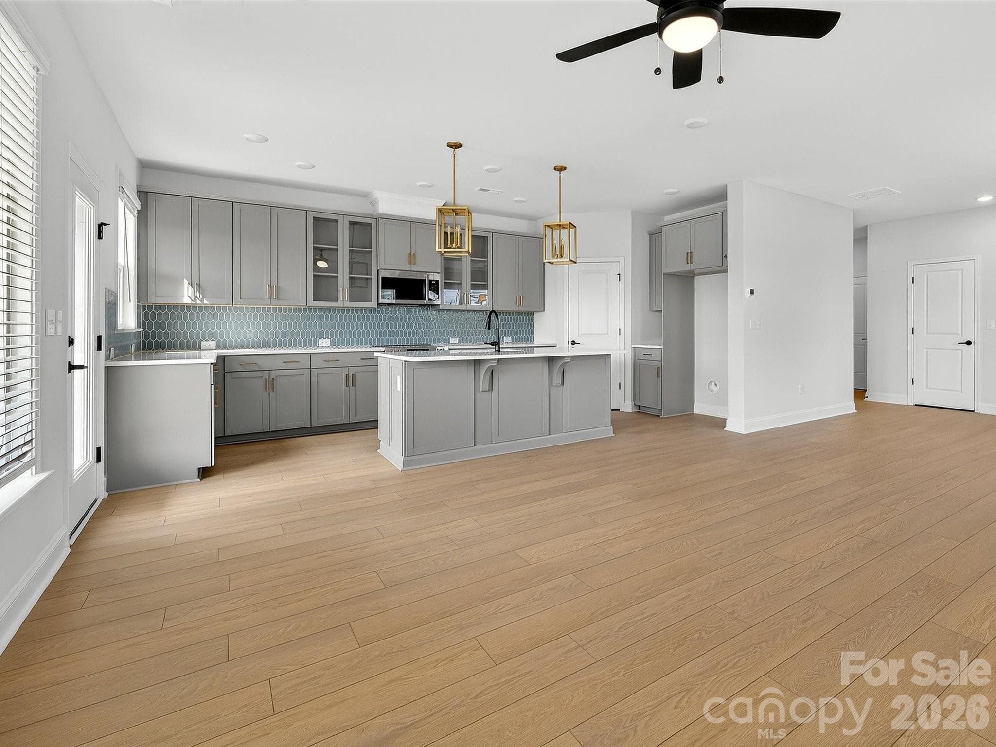 42" cabinets with soft close doors and drawers, quartz countertops, tile backsplash. Frigidaire gallery appliances. Microwave is exhaust vented to the outside. Large pantry with solid shelving - 218 Quartz Hill Way, Waxhaw