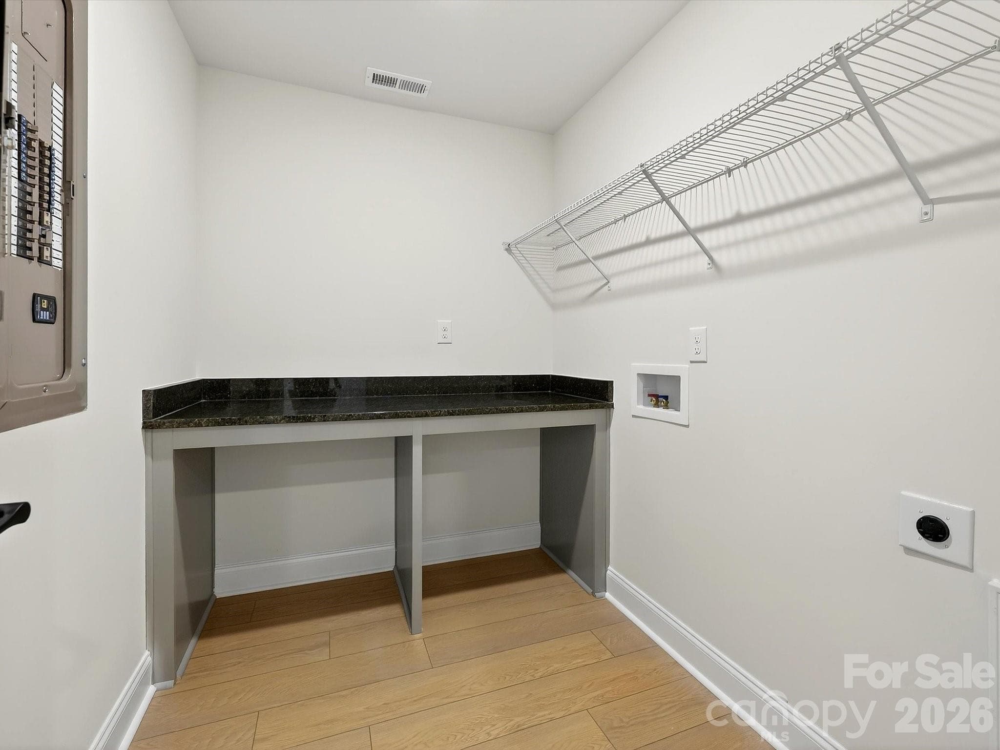 Laundry room with folding table - 218 Quartz Hill Way, Waxhaw
