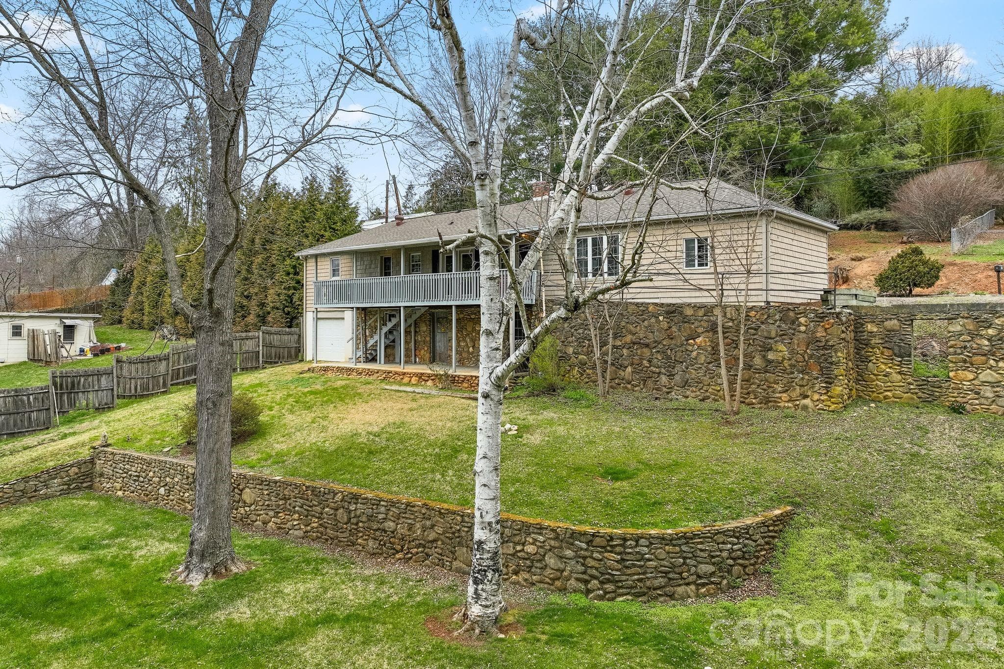 The creek (Pharr Branch) is located about 50' downhill from the river birch and maple trees - 212 Holtzclaw Street, Canton