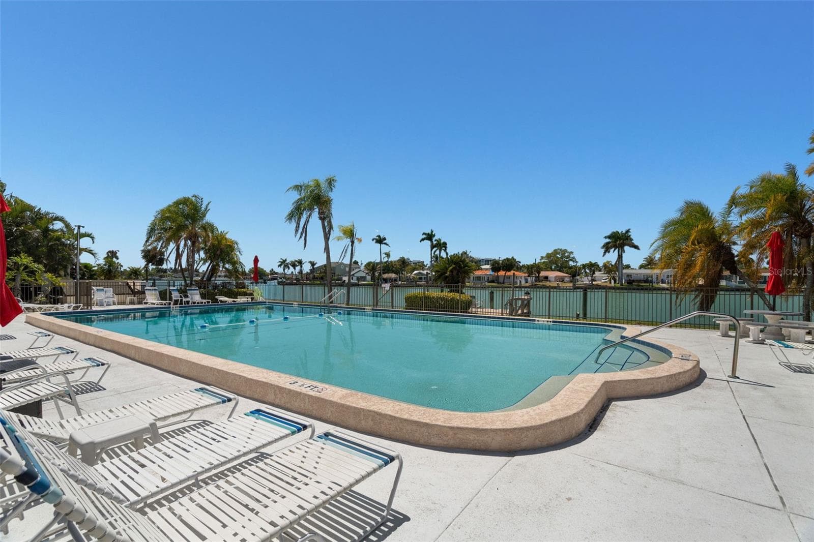Heated waterfront pool overlooking Boca Ciega Bay - 505 PLAZA SEVILLE CT #11, TREASURE ISLAND