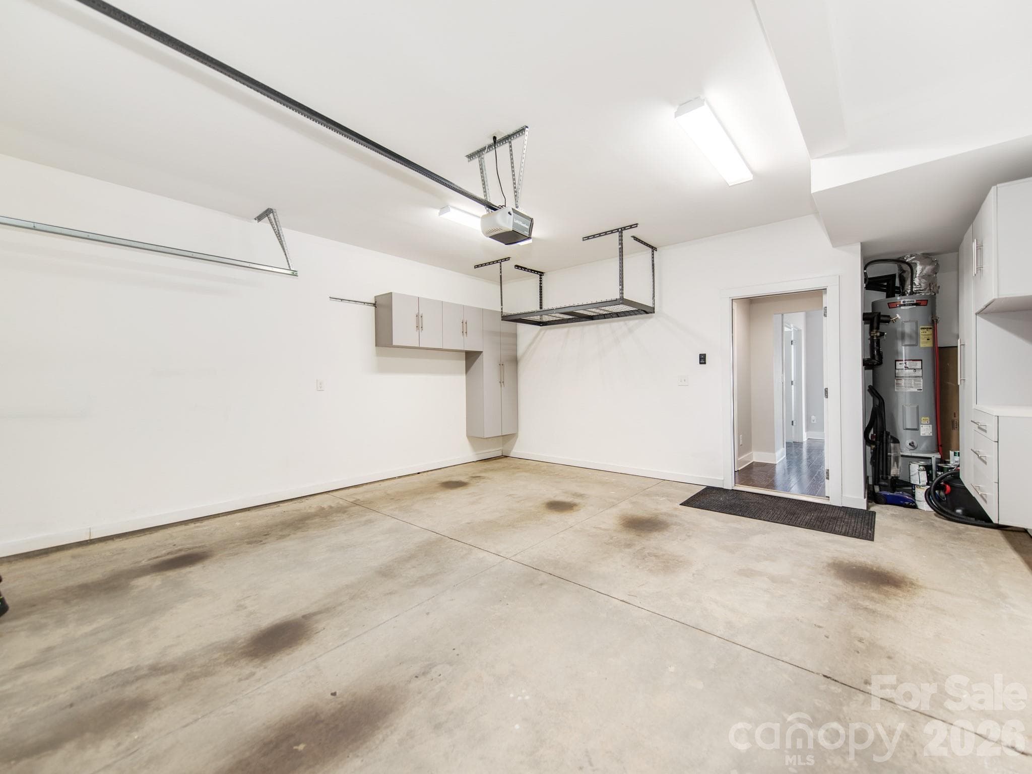Garage on main level with built-in storage cabinets. - 436 Southend Crossing Lane, Charlotte