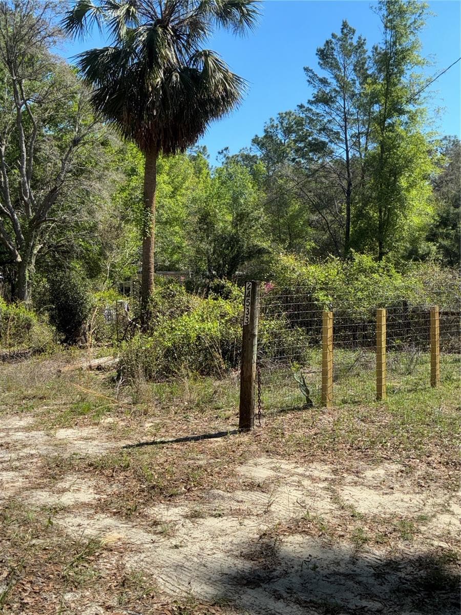 Driveway entrance to property, metal gate with chain and padlock secures the property which is fenced with field fence. - 24533 PINK PANTHER RD, PAISLEY