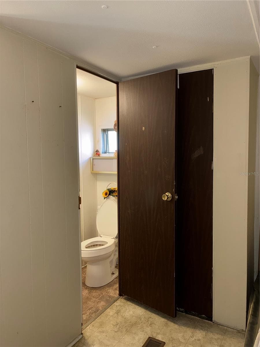 Entrance to half bath from the second bedroom. - 24533 PINK PANTHER RD, PAISLEY