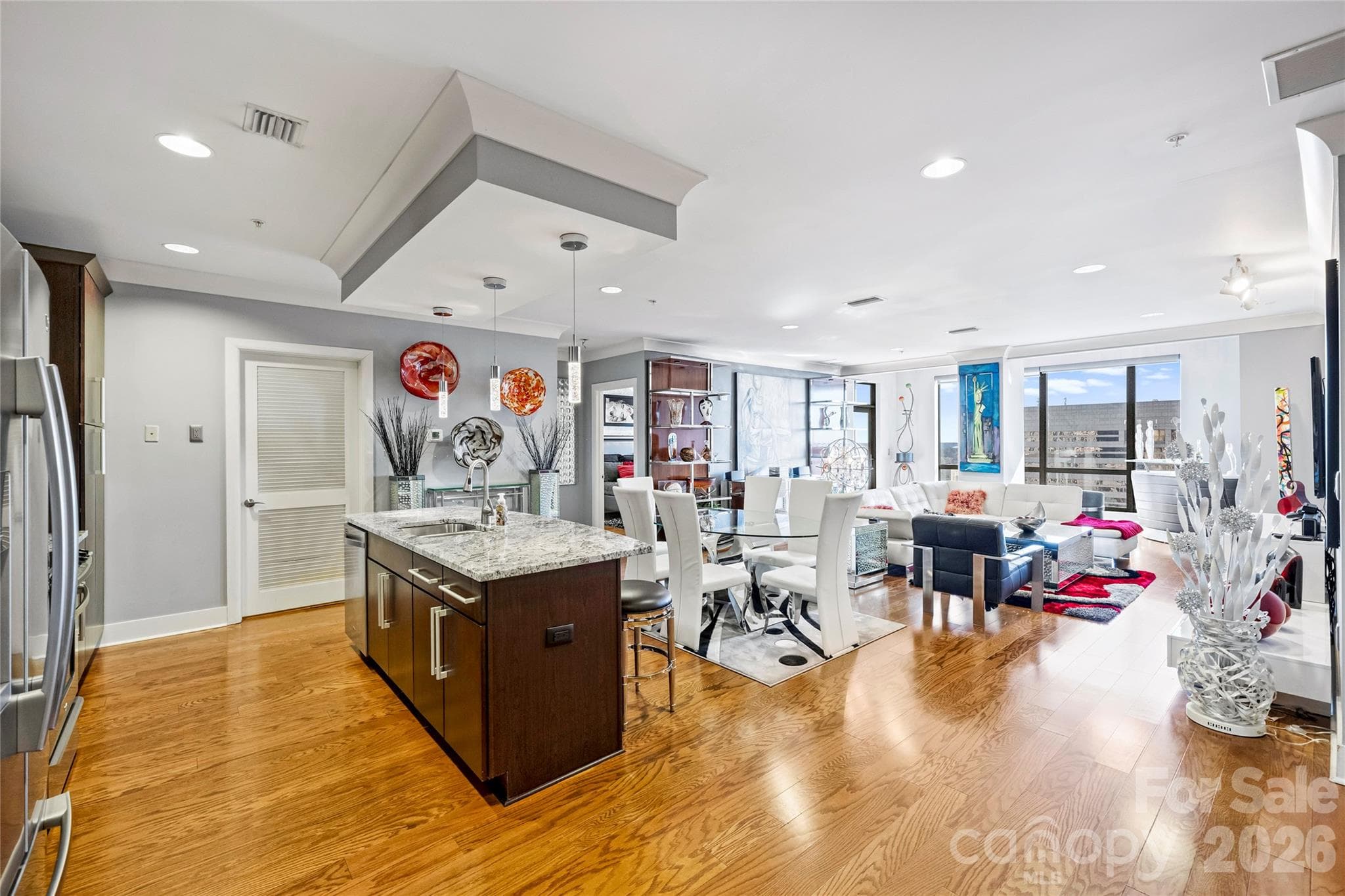 Kitchen with large conversation island and seamless flow to living space - 222 S Caldwell Street, Charlotte