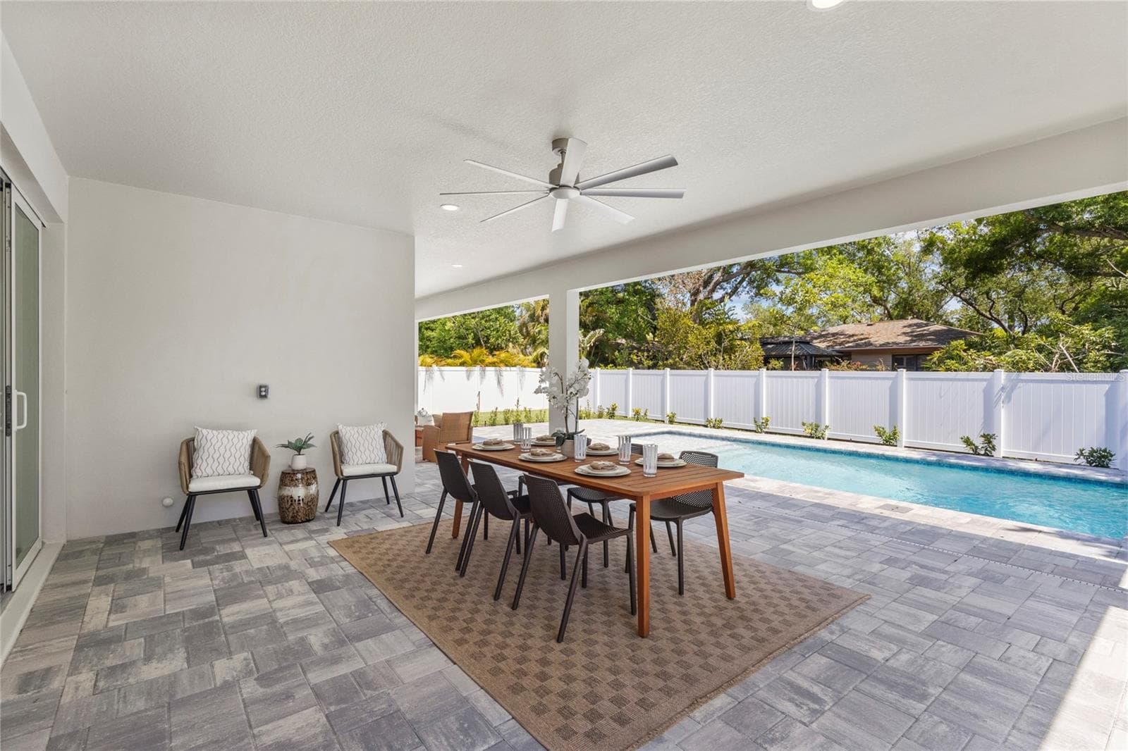 Behind the white pillow chairs the wall is pre-plumbed for an outdoor kitchen. - 217 S SHADE AVE, SARASOTA