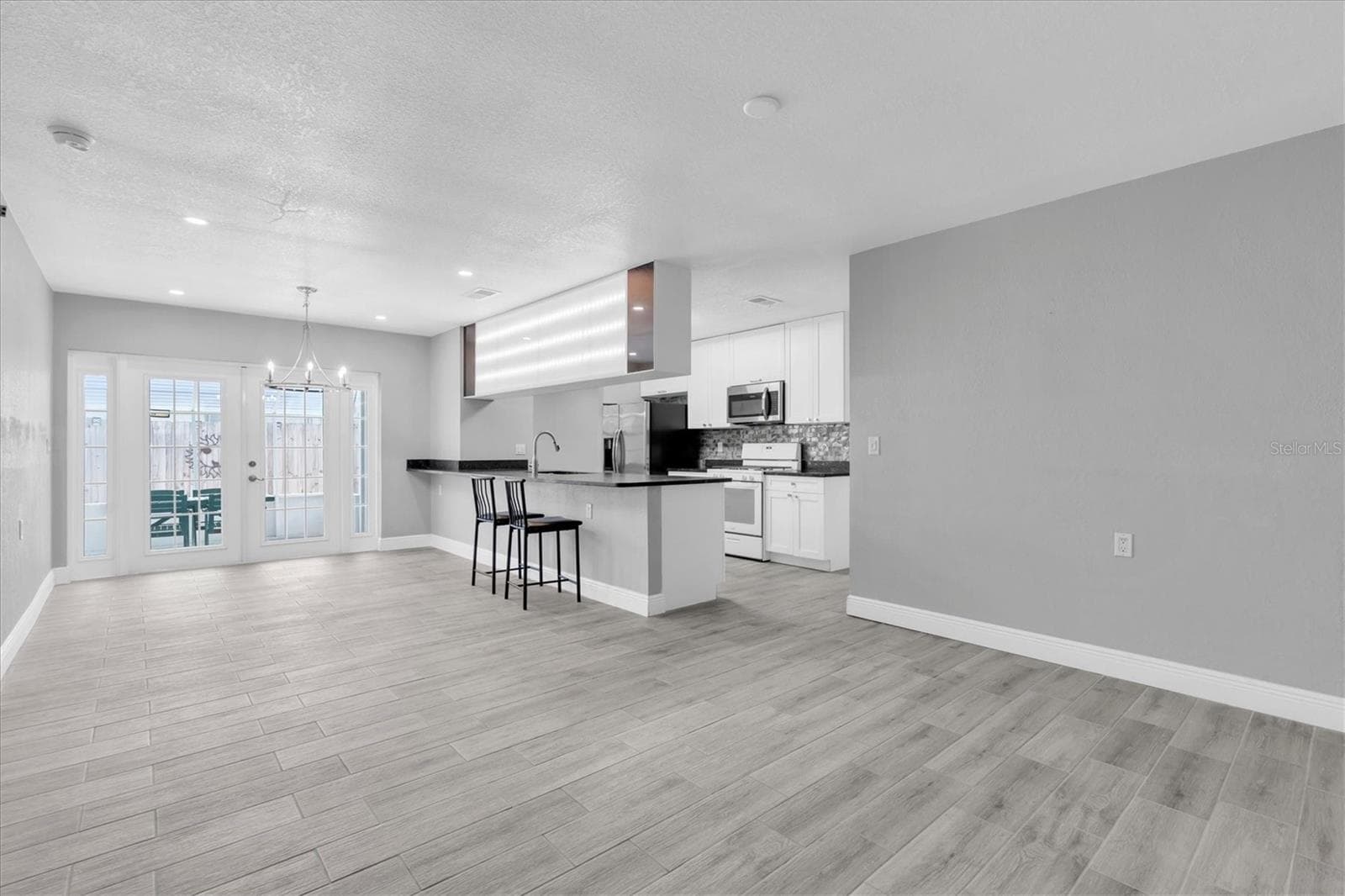Dining room and Kitchen with patio entrance - 5619 DENVER ST NE, ST PETERSBURG