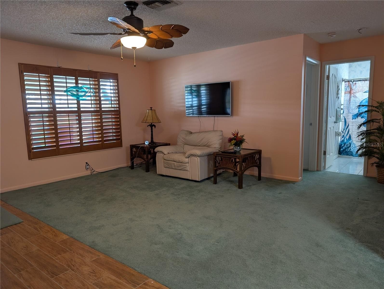 Living room is partially carpeted and partially tiled. - 9204 36TH WAY N #6, PINELLAS PARK