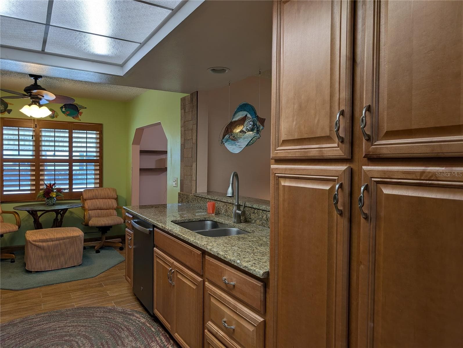 Dishwasher was installed 2025.  Two pantries...one on each side provide great storage.  Pass thru window to Florida room is very convenient.  Deep stainless sink w/pot faucet for easier cleanup. - 9204 36TH WAY N #6, PINELLAS PARK