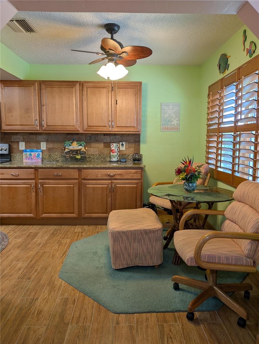 Traditional eat in kitchen area is now a casual dining area for two/three to enjoy sitting by the window and offers much more cabinetry/counterspace. - 9204 36TH WAY N #6, PINELLAS PARK