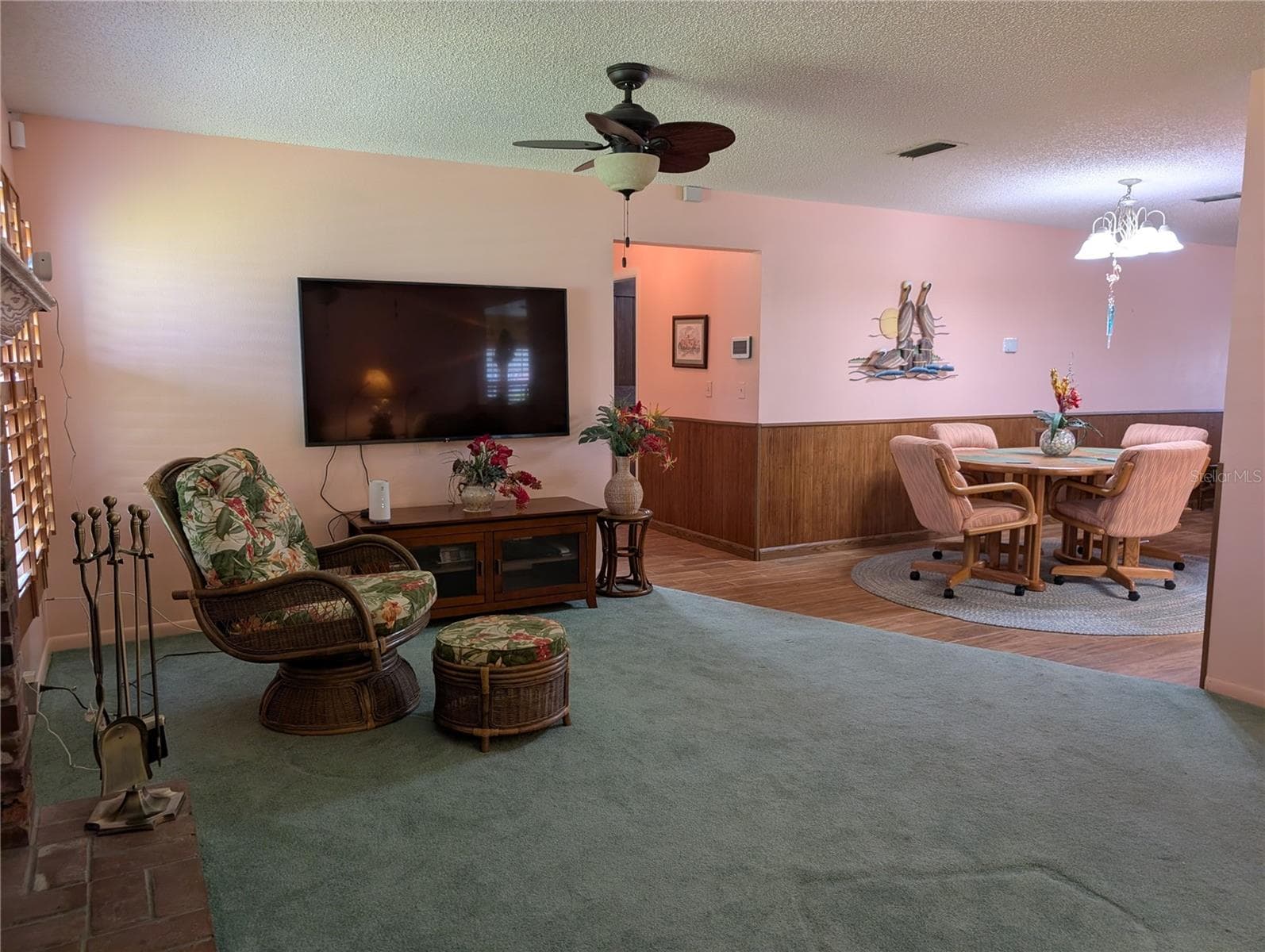 View from Florida room to hallway leading to interior laundry and Primary suite. - 9204 36TH WAY N #6, PINELLAS PARK
