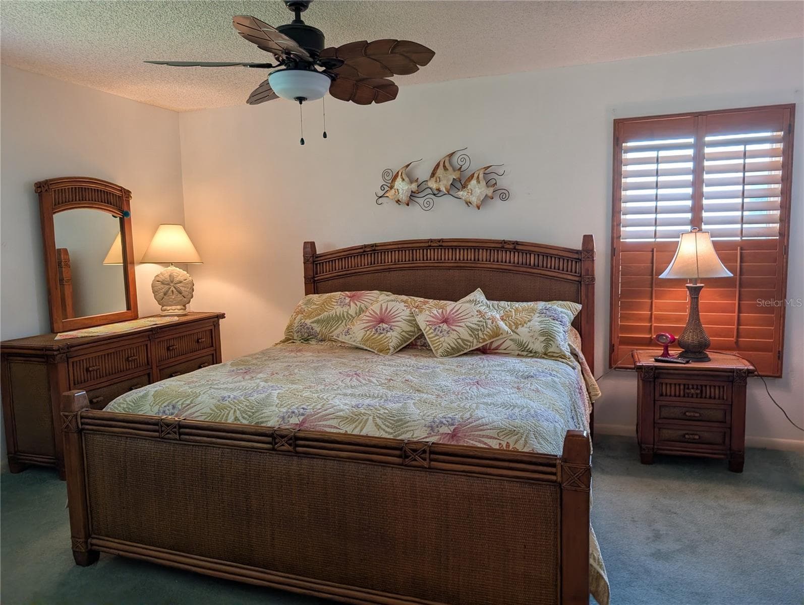 Spacious master bedroom features carpeting, tropical ceiling fan and the honey oak plantation shutters. - 9204 36TH WAY N #6, PINELLAS PARK