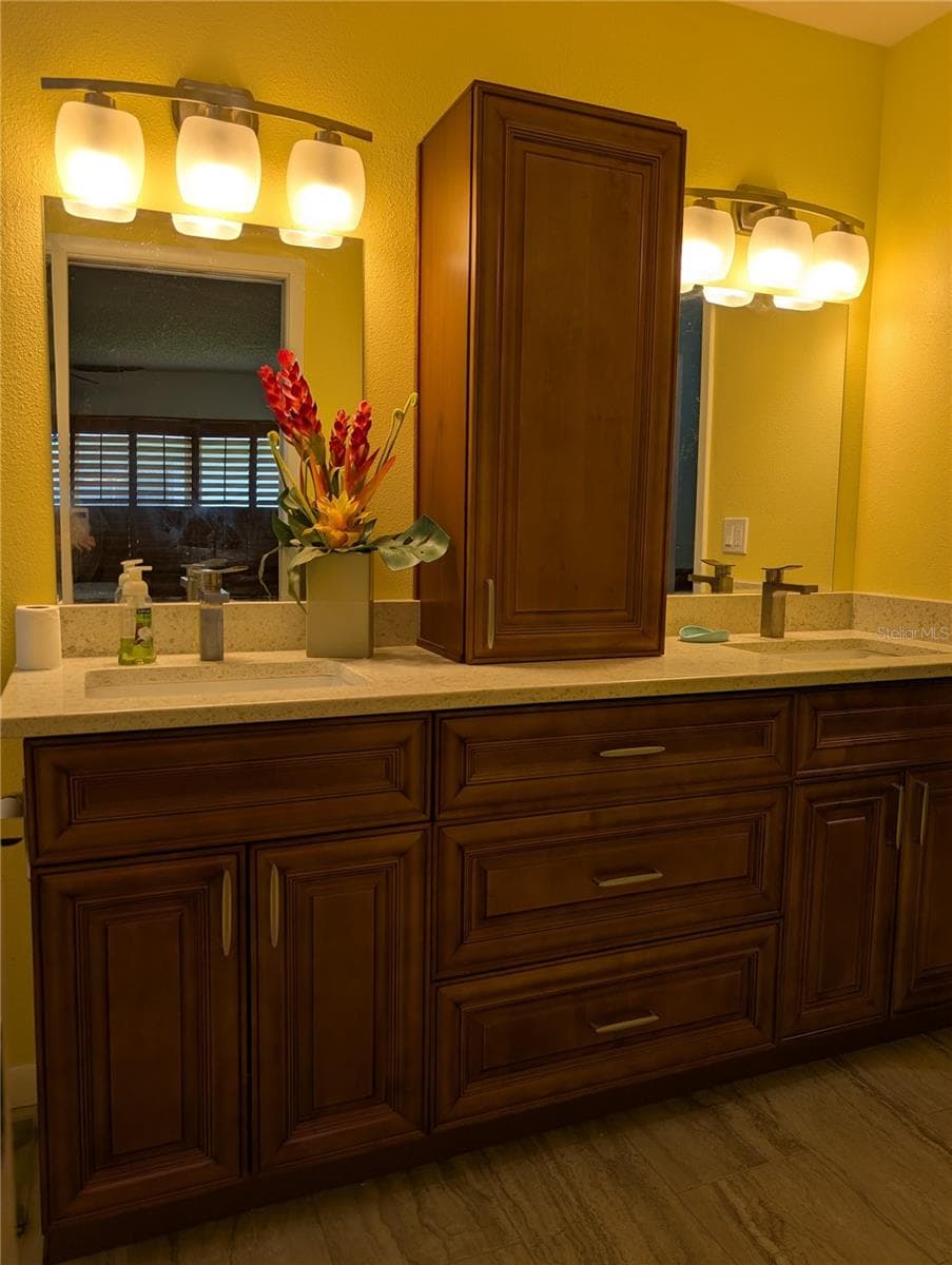 Primary ensuite bathroom was totally remodeled 2020. It features Honey oak cabinets, stone countertops w/undermount sinks, brushed nickel hardware and beautiful tile flooring to match shower tile. - 9204 36TH WAY N #6, PINELLAS PARK