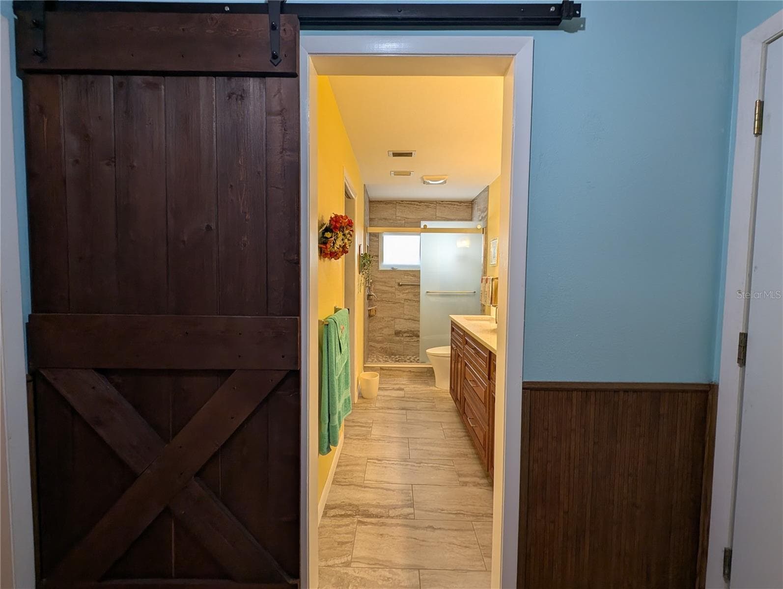 View from laundry into primary bathroom. - 9204 36TH WAY N #6, PINELLAS PARK