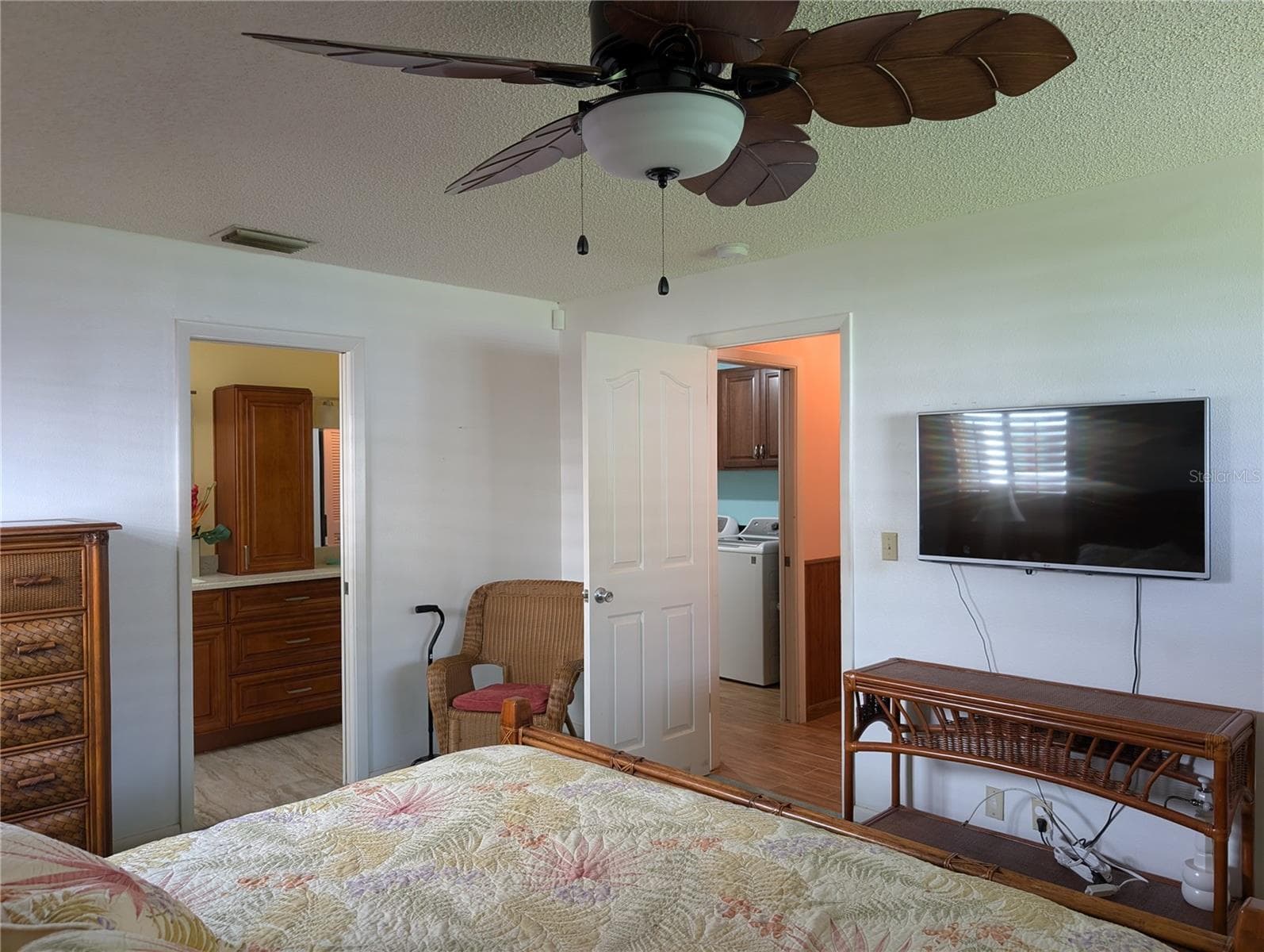 View thru primary bedroom to bathroom and hallway entry. Laundry visible to left of bedroom exit. - 9204 36TH WAY N #6, PINELLAS PARK