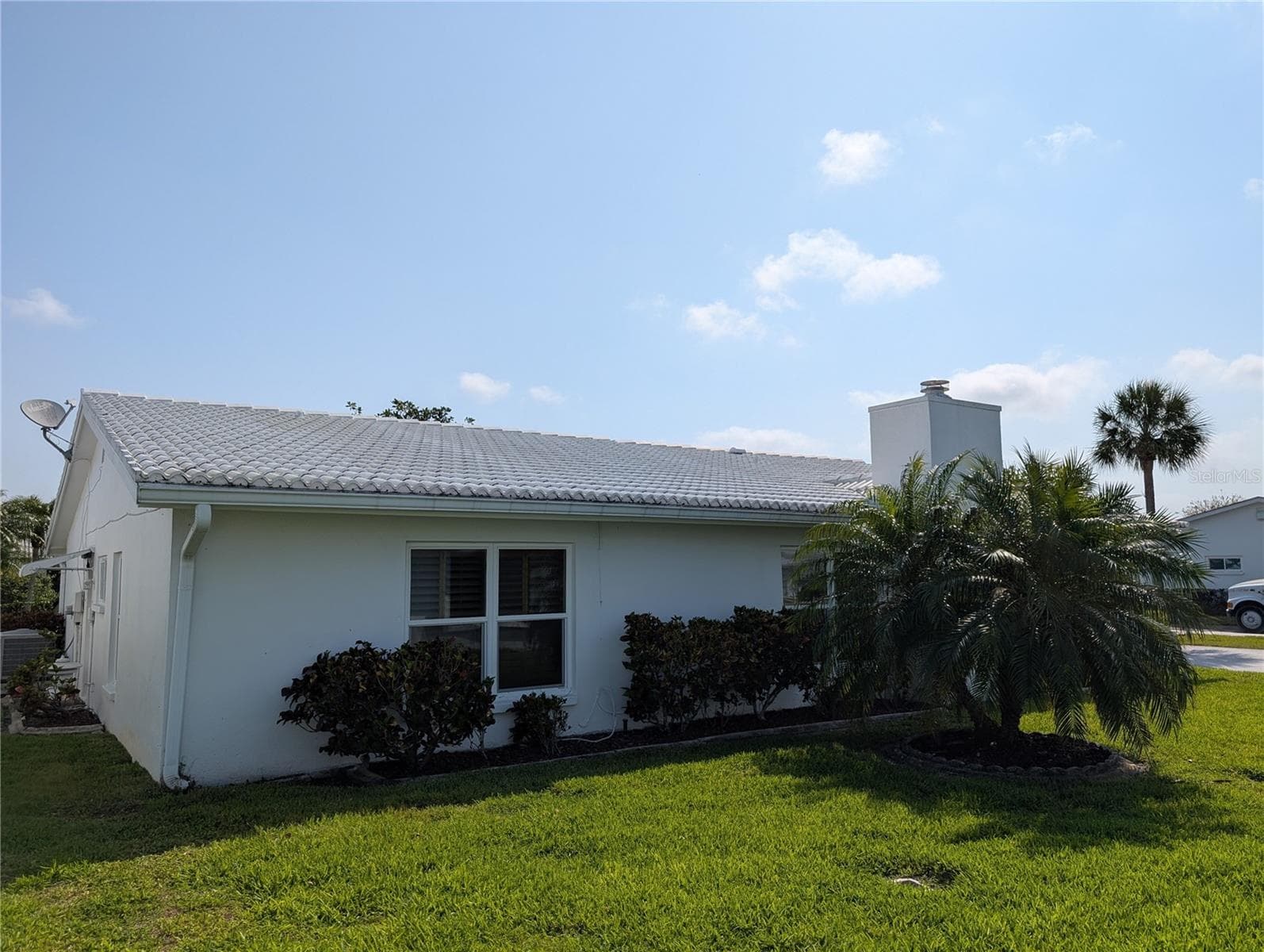 Exterior rear view of Florida room and primary bedroom.  Exterior of home is painted by the association on a scheduled basis. - 9204 36TH WAY N #6, PINELLAS PARK