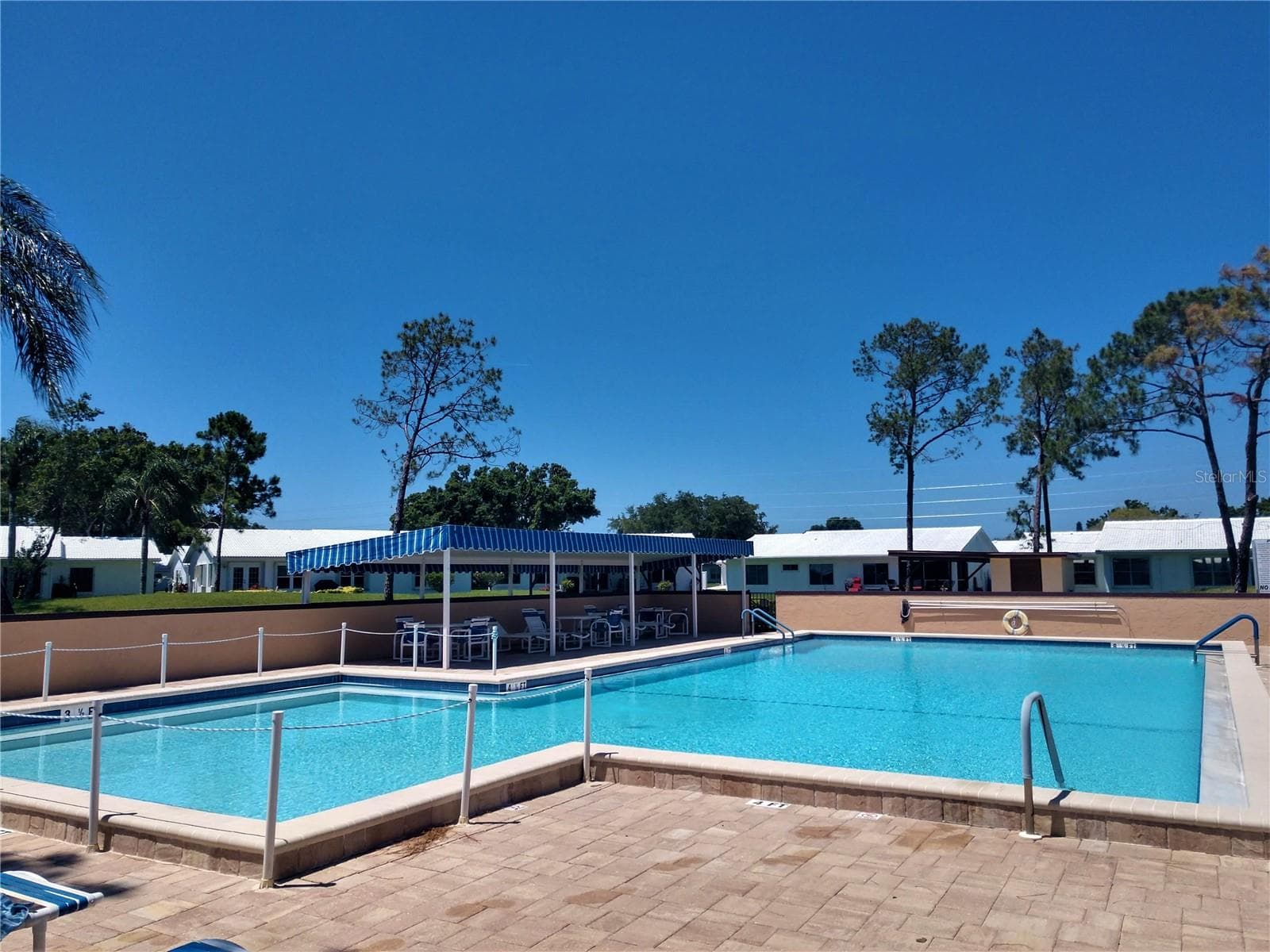 For the non-sunseekers, there is a covered sitting area to enjoy the pool activities. - 9204 36TH WAY N #6, PINELLAS PARK