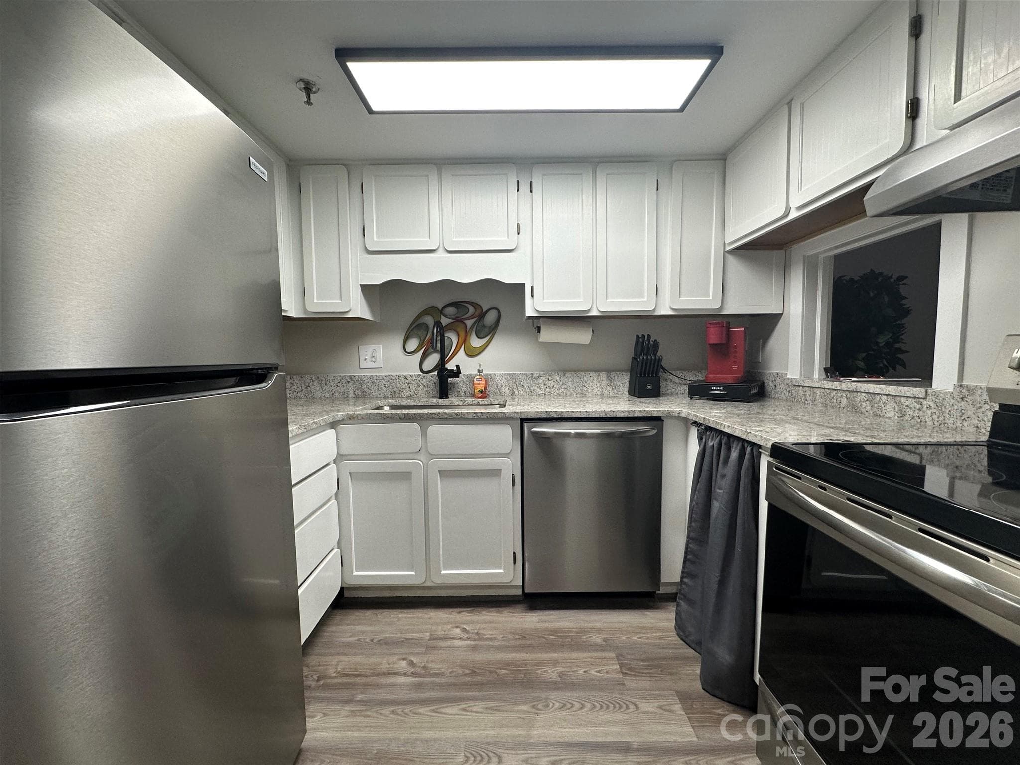 Enjoy a beautifully updated kitchen with sleek granite countertops and modern stainless steel appliances - Winston Salem