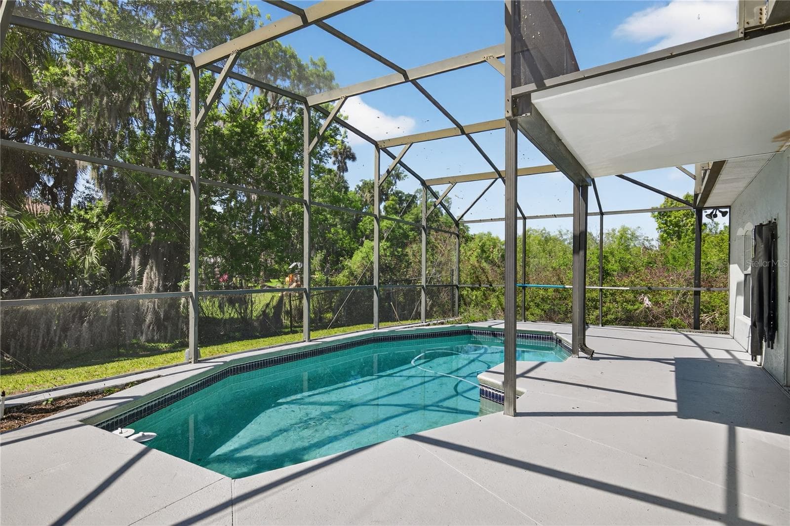 Screened Pool and Deck perfect for relaxation and enjoyment, offering privacy and protection from the elements. - 28931 BEAUCLAIRE DR, TAVARES