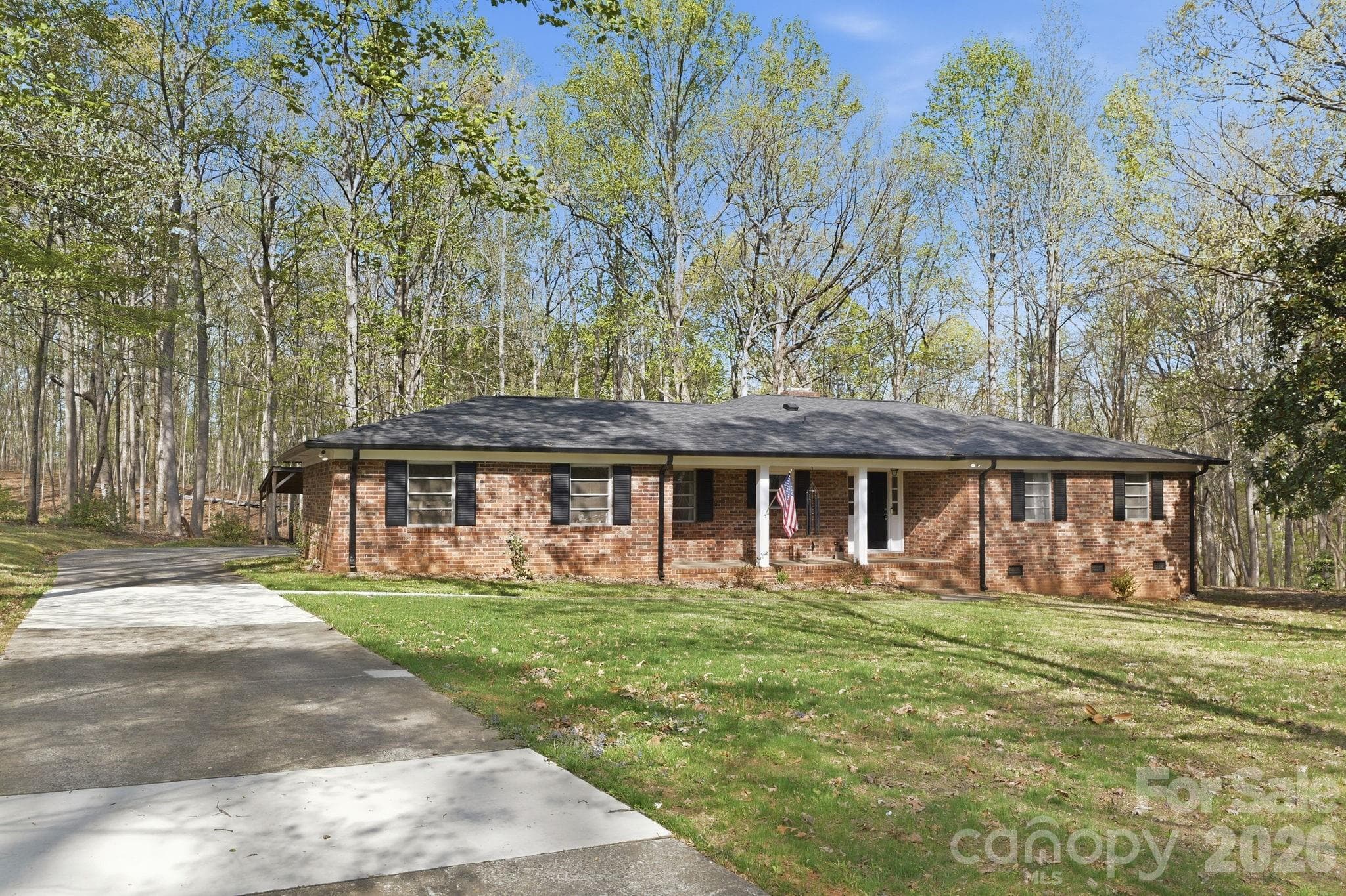 Over an acre to the left of the driveway leaves room to build another home if desired.  Fresh concrete on older parts of driveway. - Charlotte