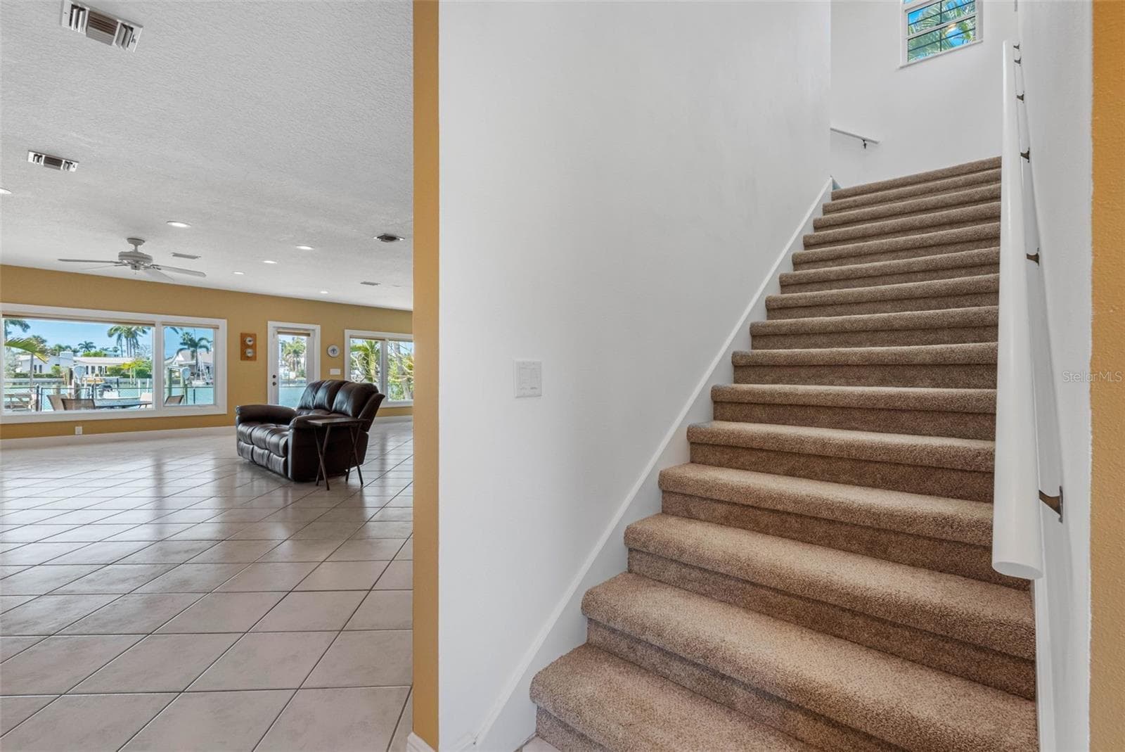 Stairs to the primary suite and office/guest bedroom/nursery. - 11260 5TH ST E, TREASURE ISLAND