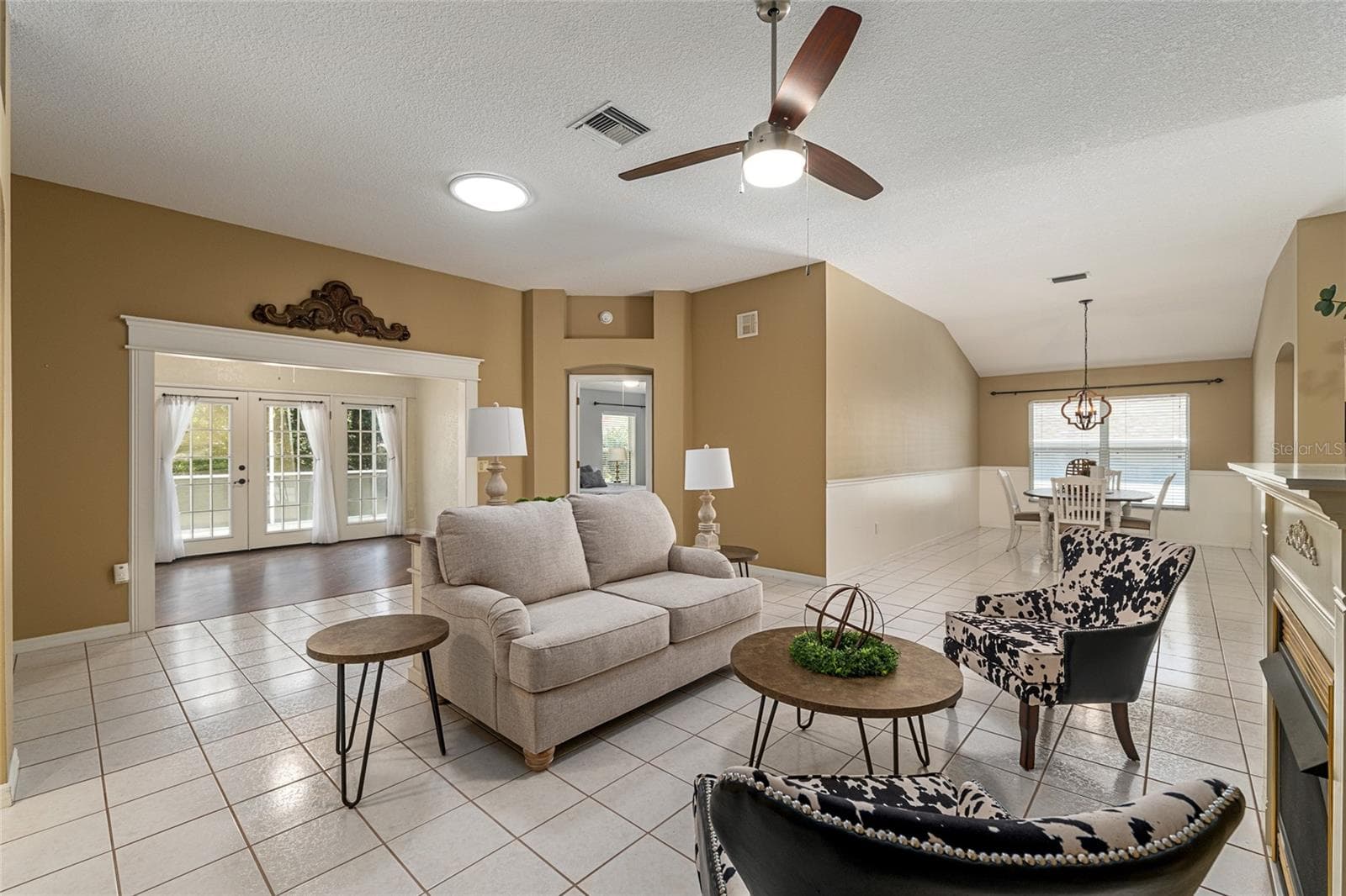Living & Dining Area: Open-concept layout connects the living room to the dining space, offering flexibility for everyday living and entertaining. - 110 CHULA VISTA AVE, LADY LAKE