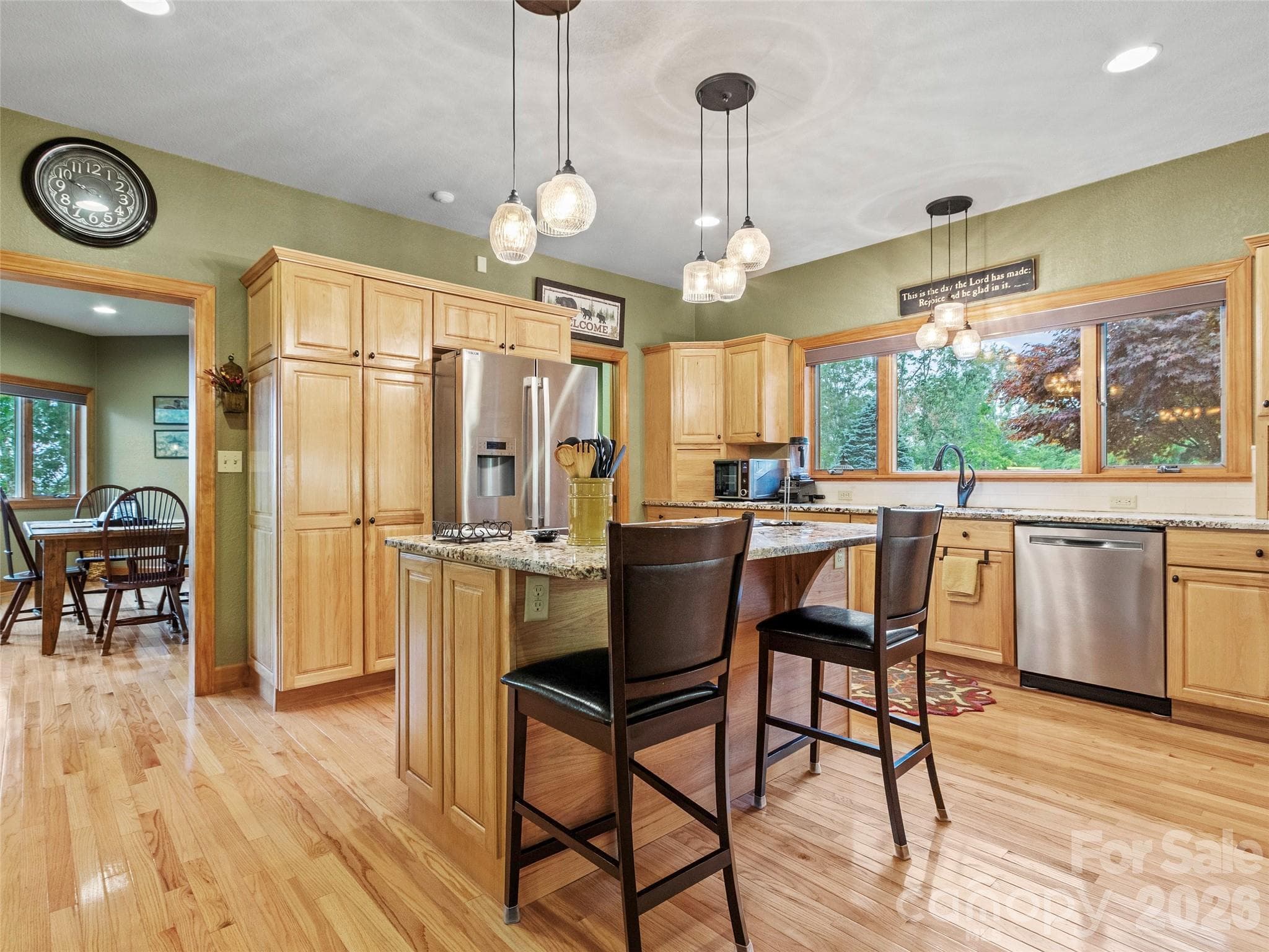 Gourmet kitchen with granite island and BOSCH appliances, double oven, induction cook top, & wine/beverage fridge - 151 Austin Mountain Drive, Burnsville