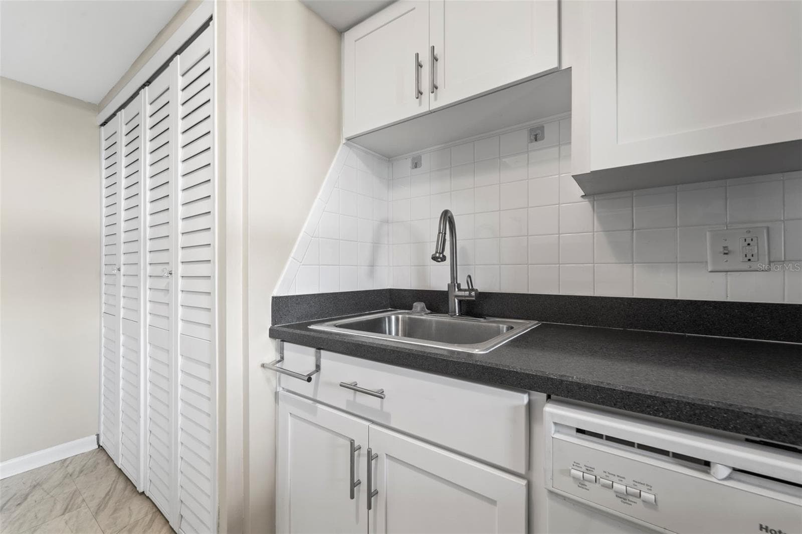 Kitchen with nice white cabinets...washer and dryer are in the cabinet on the left of the photo - 1 WINDRUSH BLVD #24, INDIAN ROCKS BEACH