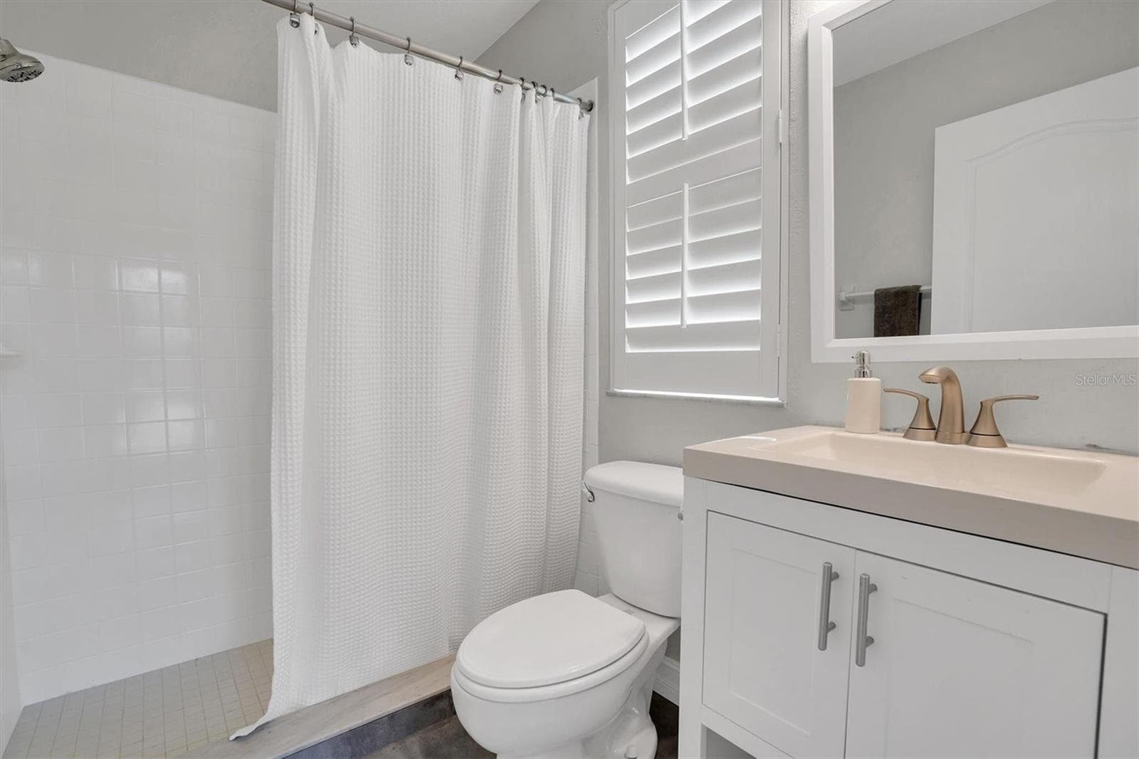 downstairs bathroom, pool entrance - 906 LANDMARK CIR S, TIERRA VERDE