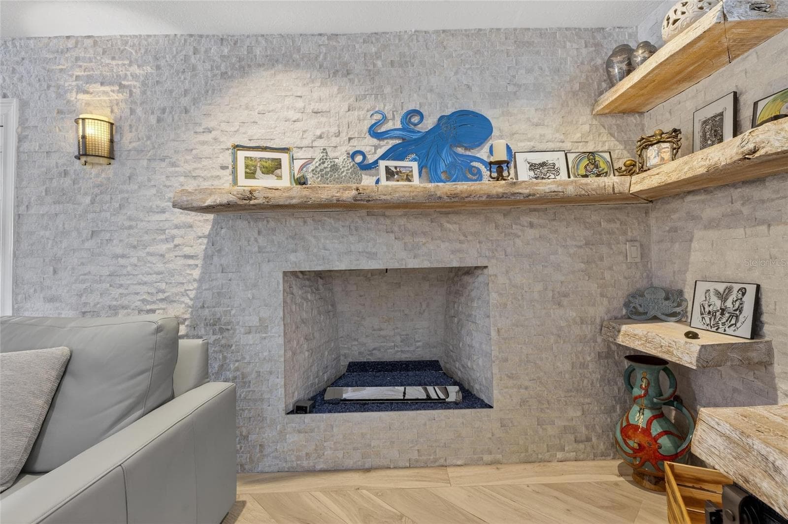 Stone gas fireplace in Living Room - 931 GULF BLVD, BELLEAIR BEACH