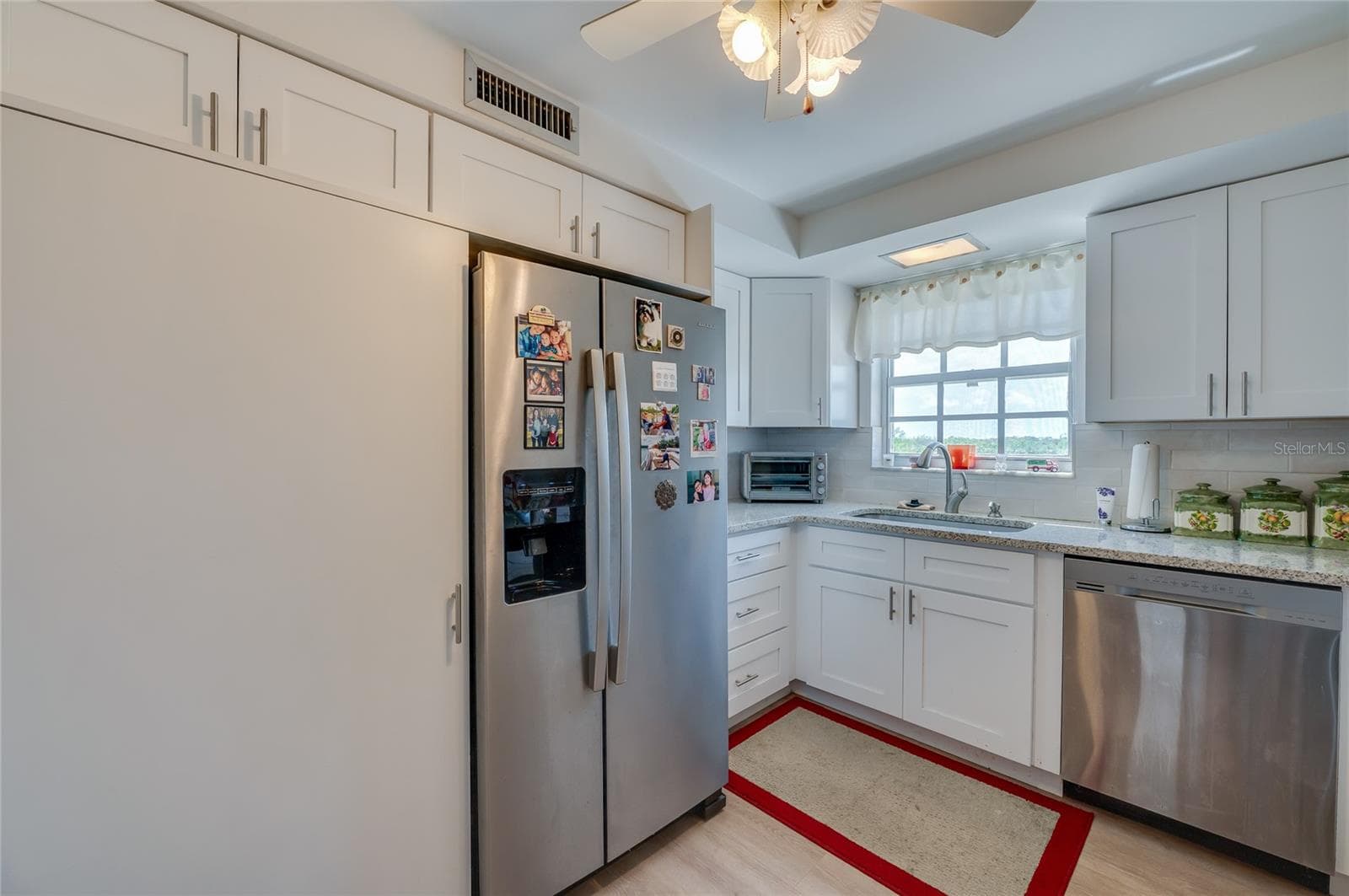 Full-size stack washer/dryer to left of refrigerator - 404 S BEACH ST #230 (604), DAYTONA BEACH