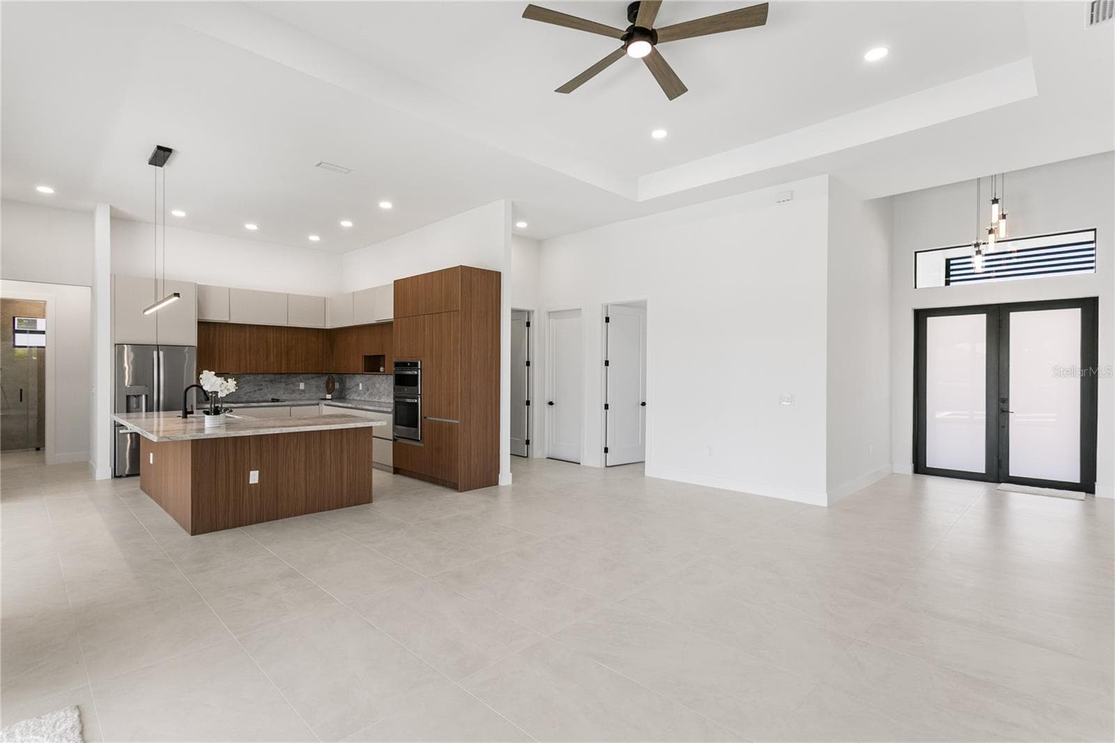 High-end finishes include MATTE PORCELAIN TILE throughout, IMPACT-RESISTANT Low-E windows & doors, BAHAMA SHUTTERS & a welcoming COLUMNED FRONT PORCH w/ frosted DOUBLE ENTRY DOORS. - 3300 NW 1ST TER, CAPE CORAL