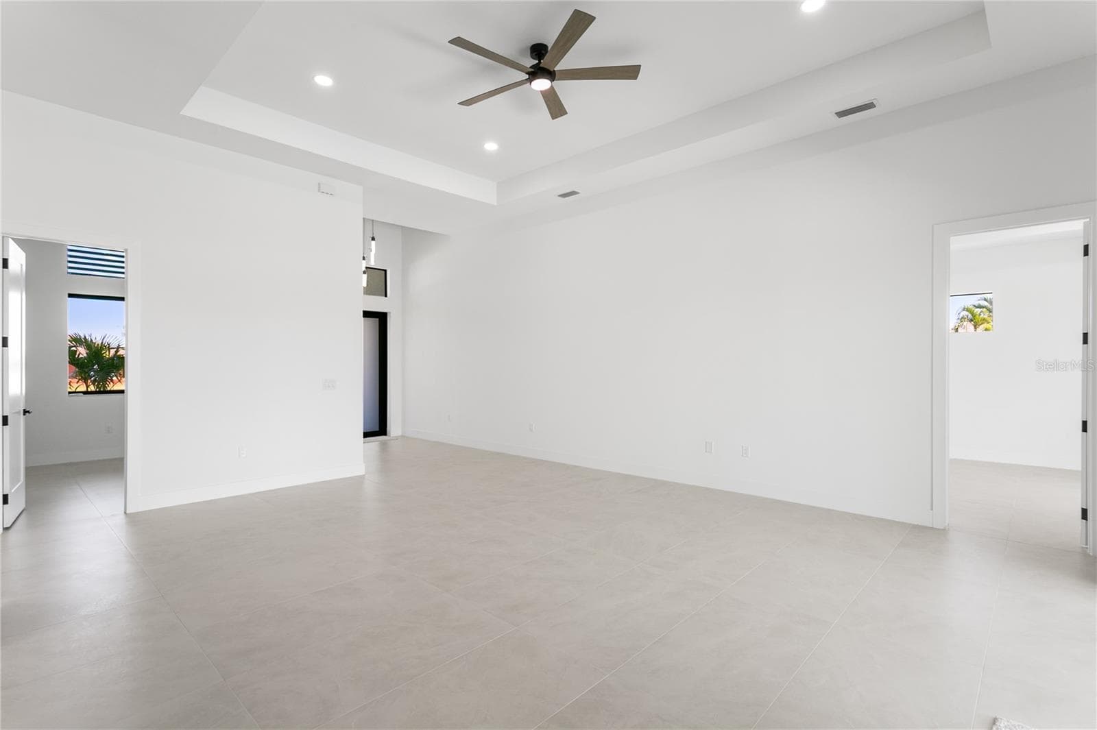 Step into an IMPRESSIVE FOYER leading to a SPACIOUS LIVING ROOM w/ soaring 16-ft COVE CEILINGS, ideal for entertaining. - 3300 NW 1ST TER, CAPE CORAL