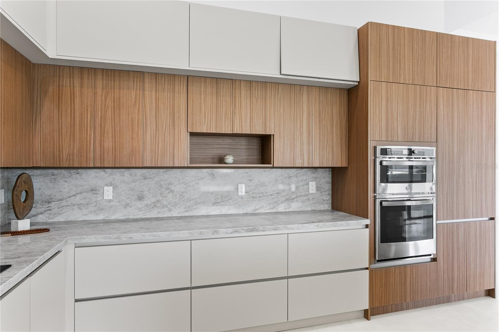 Large pantry & premium GE appliances including wall oven, microwave, electric cooktop, dishwasher, refrigerator and freezer, plus a large sink with black fixtures - 3300 NW 1ST TER, CAPE CORAL