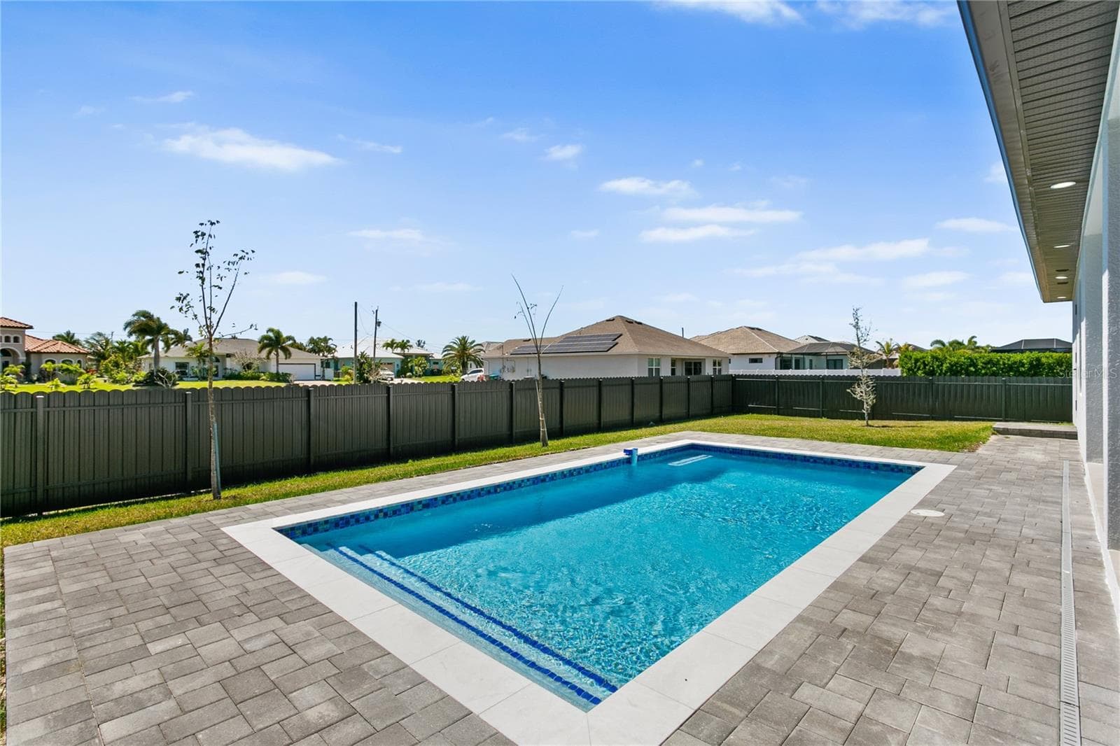Enjoy a beautifully designed pool area perfect for relaxing or entertaining year-round. - 3300 NW 1ST TER, CAPE CORAL