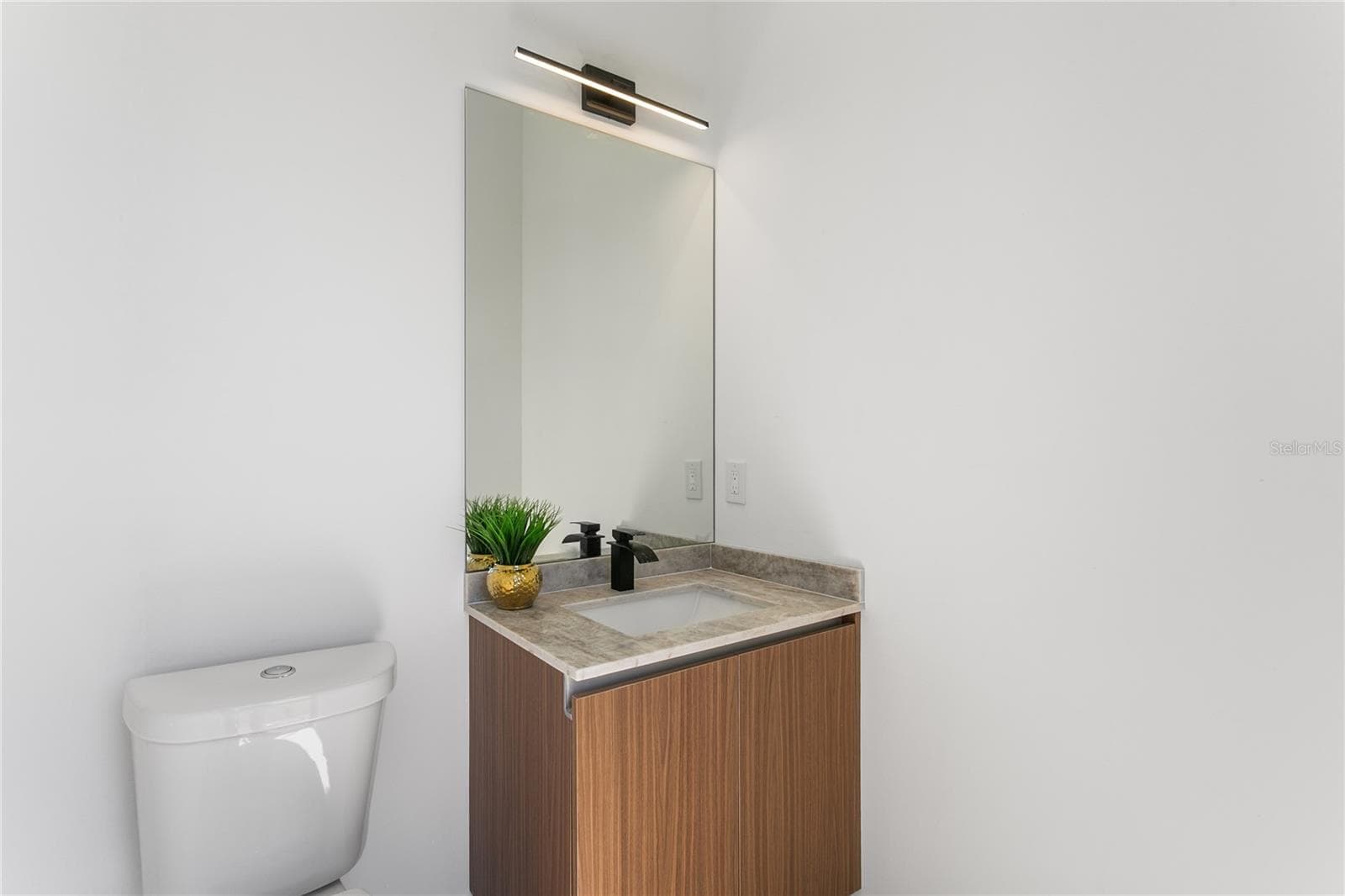 Convenient cabana half bathroom provides easy access from the pool area, perfect for guests and outdoor entertaining. - 3300 NW 1ST TER, CAPE CORAL