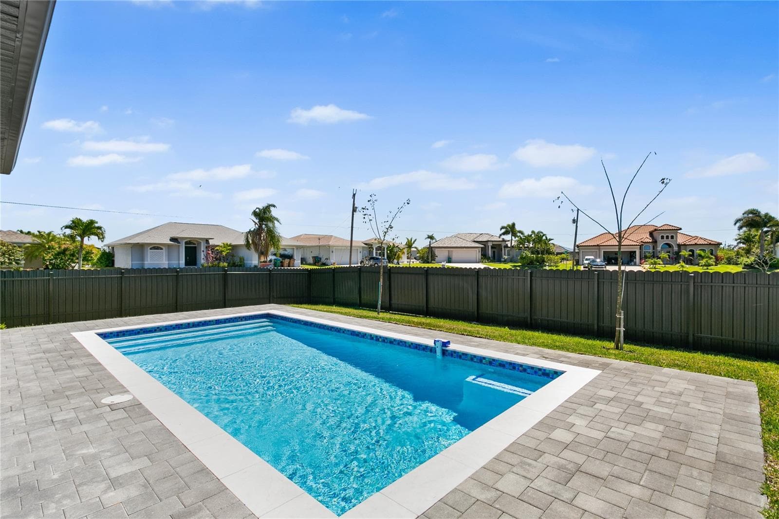 Additional features include: 3-CAR GARAGE w/ extended storage space; FULLY FENCED YEAR for privacy & pets - 3300 NW 1ST TER, CAPE CORAL