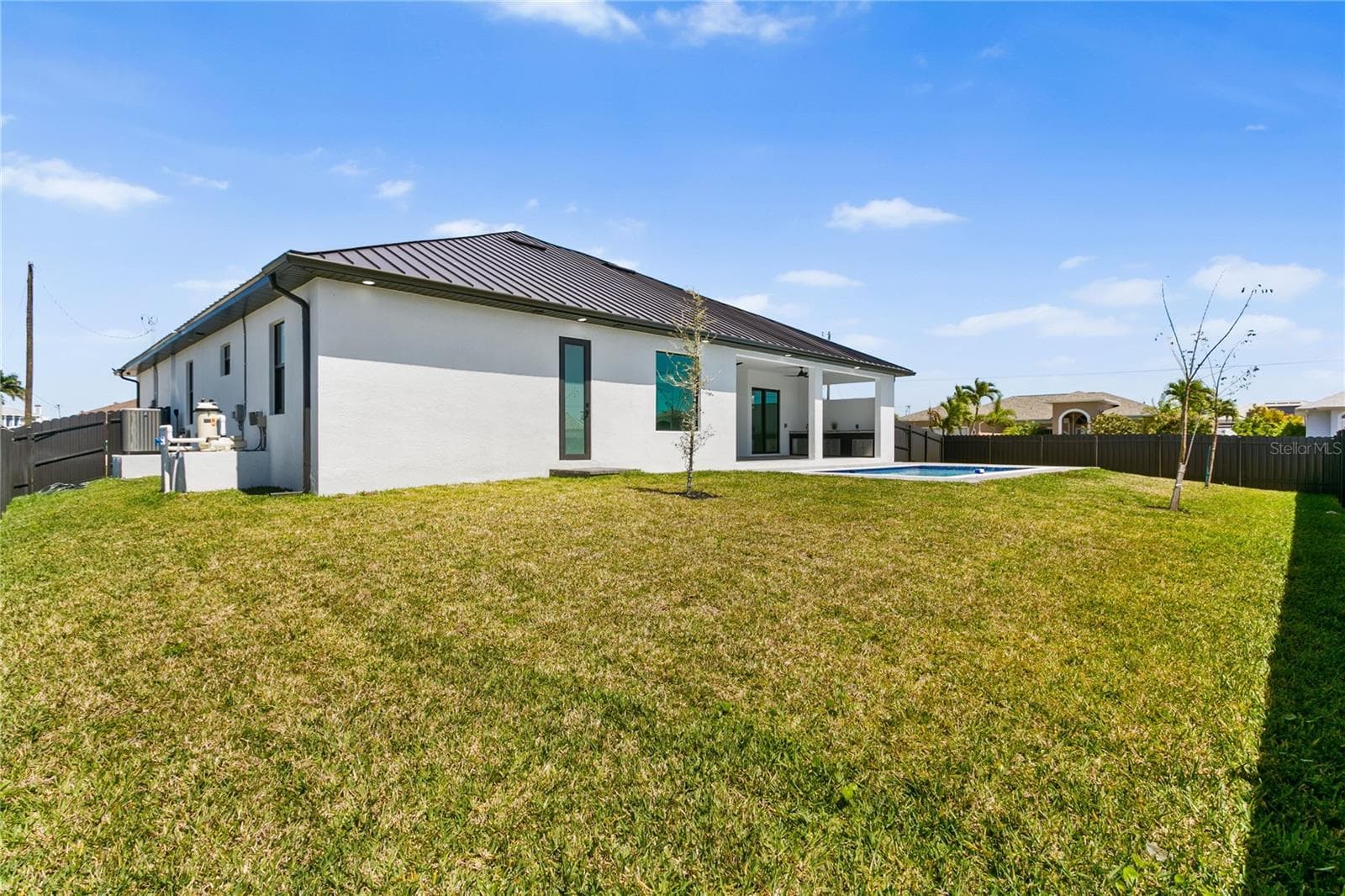 Spacious backyard offers plenty of room for a boat, trailer, or to create your own tiki retreat while providing ample space for pets to run and entertain outdoors. - 3300 NW 1ST TER, CAPE CORAL